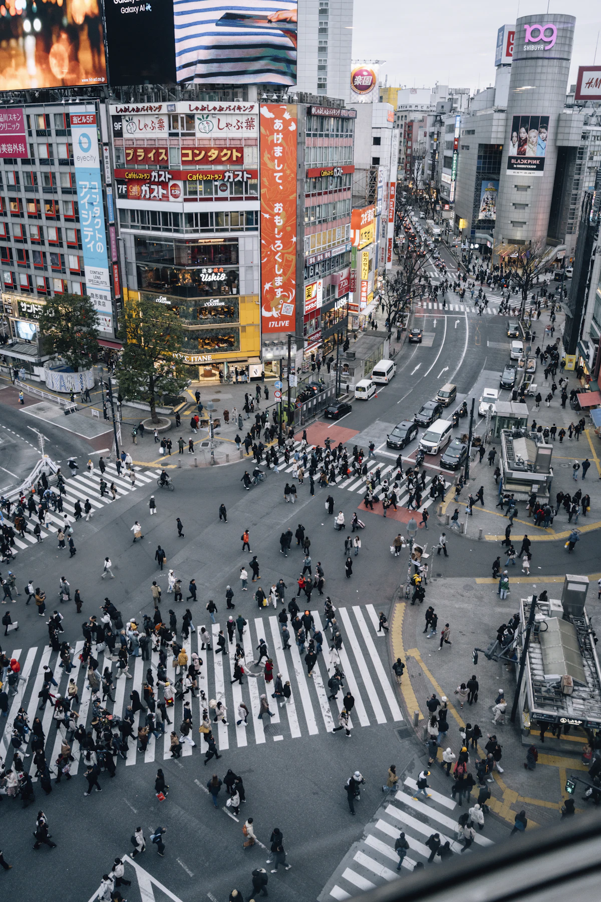 A bustling Shibuya Crossing in Tokyo with many pedestrians during peak season