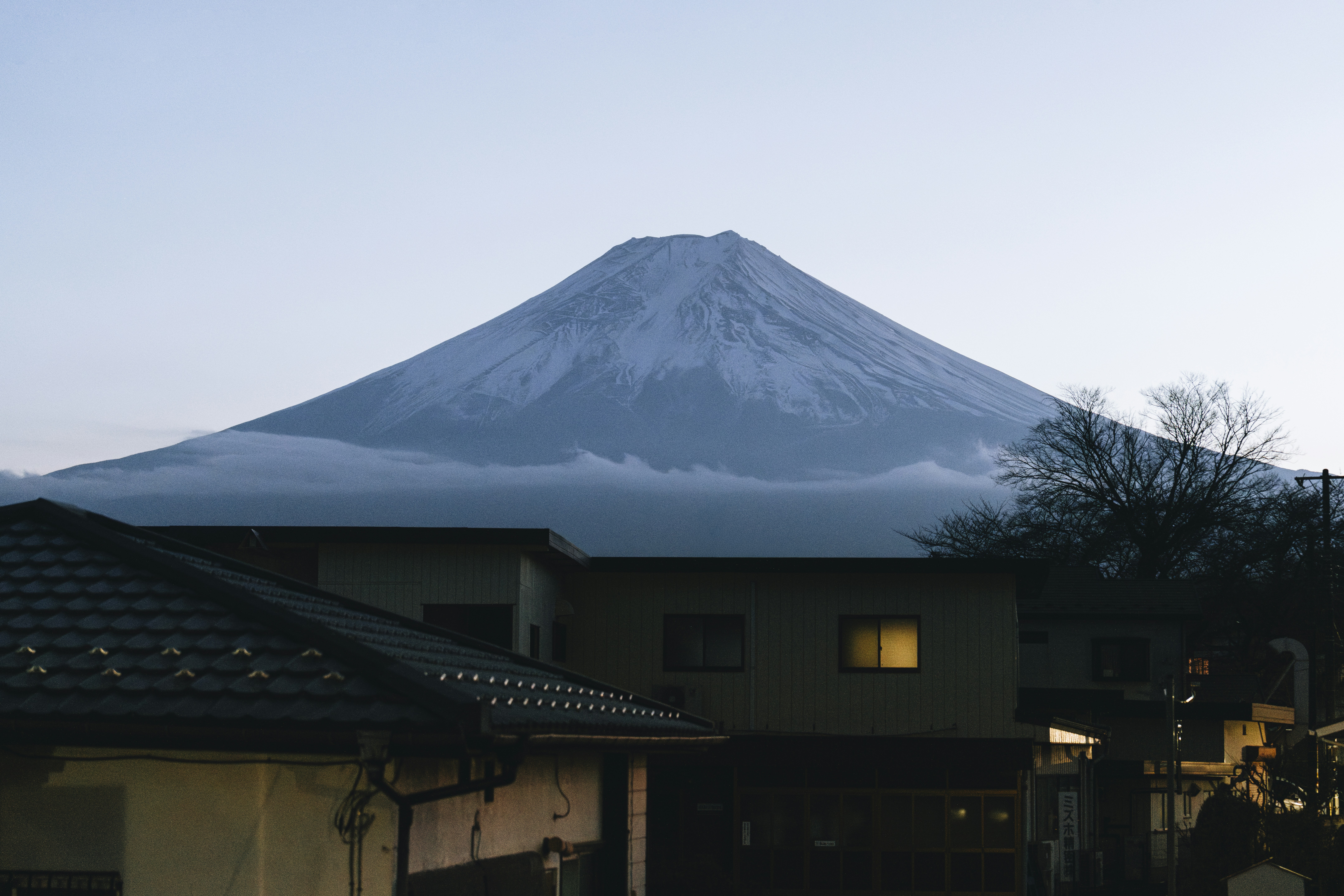 Snow-capped mount fuji looms over a quiet town.