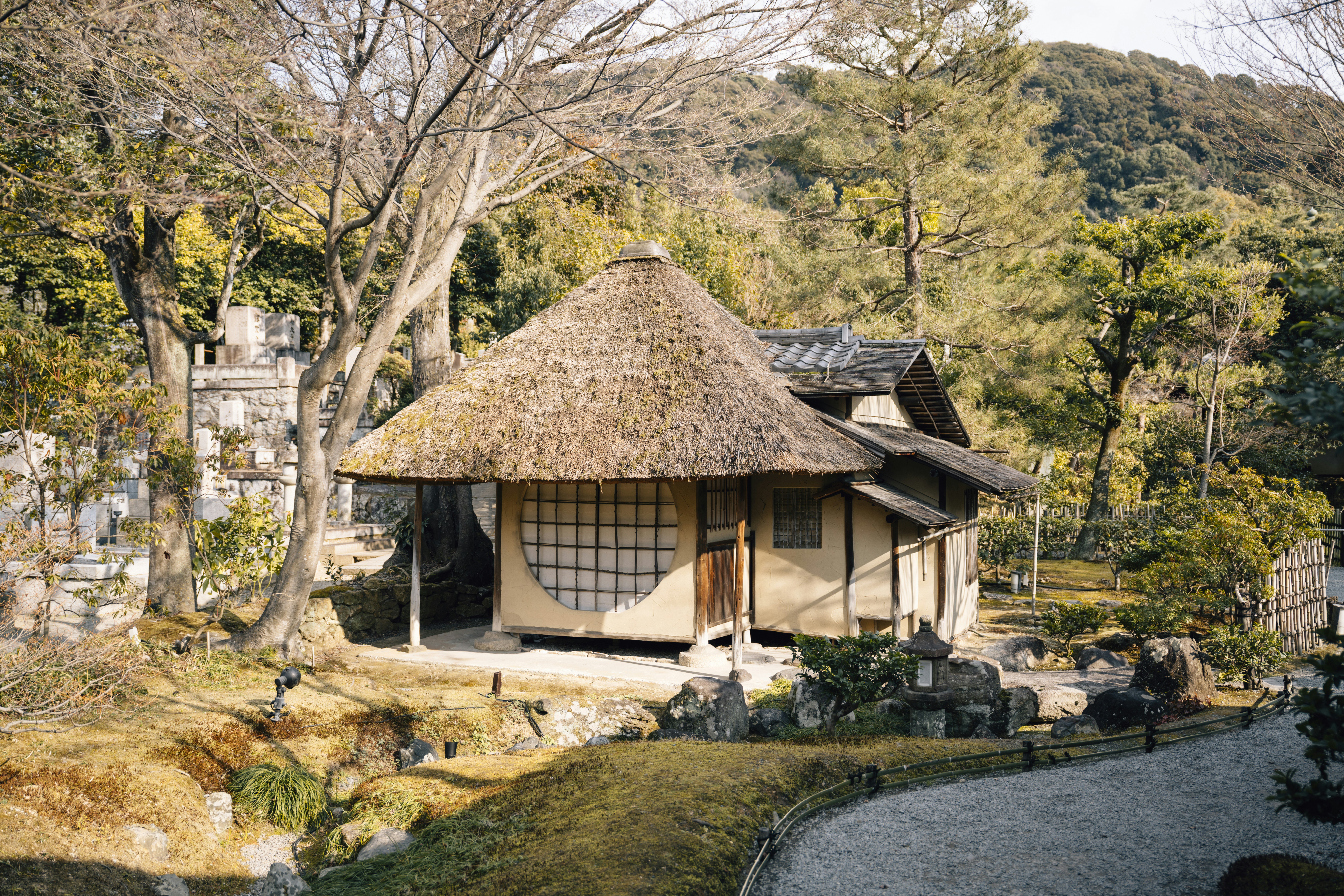 Thatched roof tea house in a serene garden setting