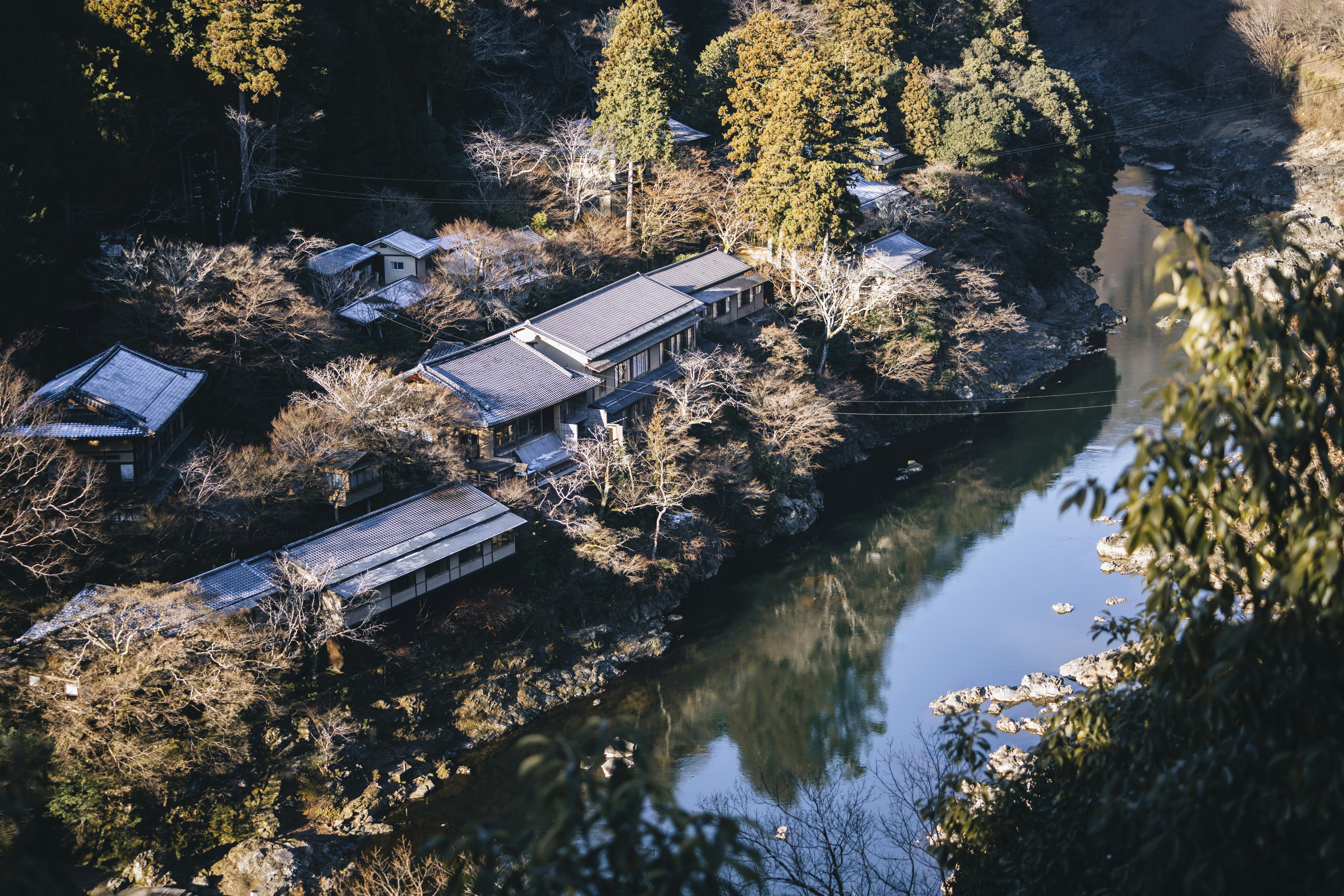 Overhead view of abandoned buildings by a river