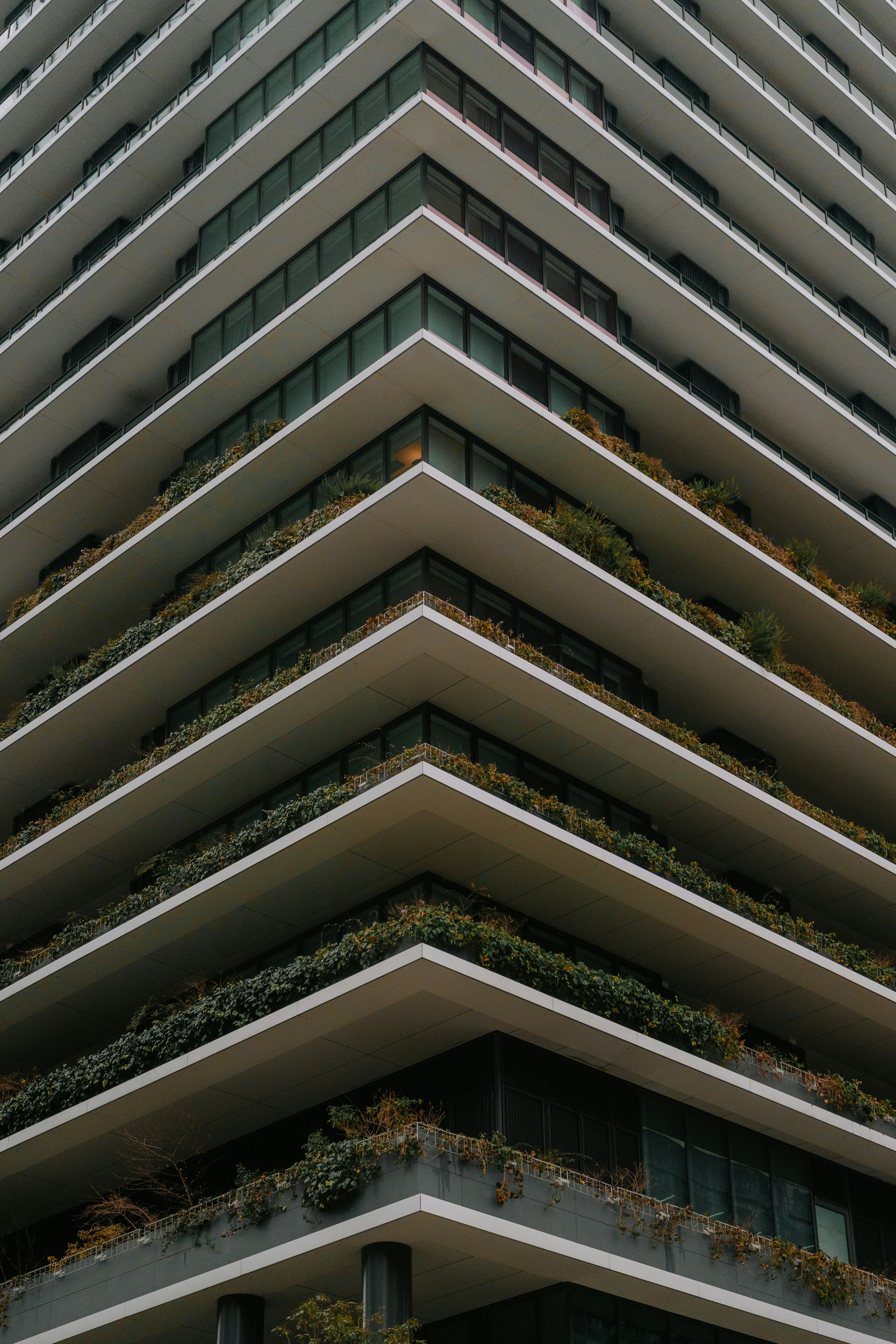 Modern building with layered balconies and greenery