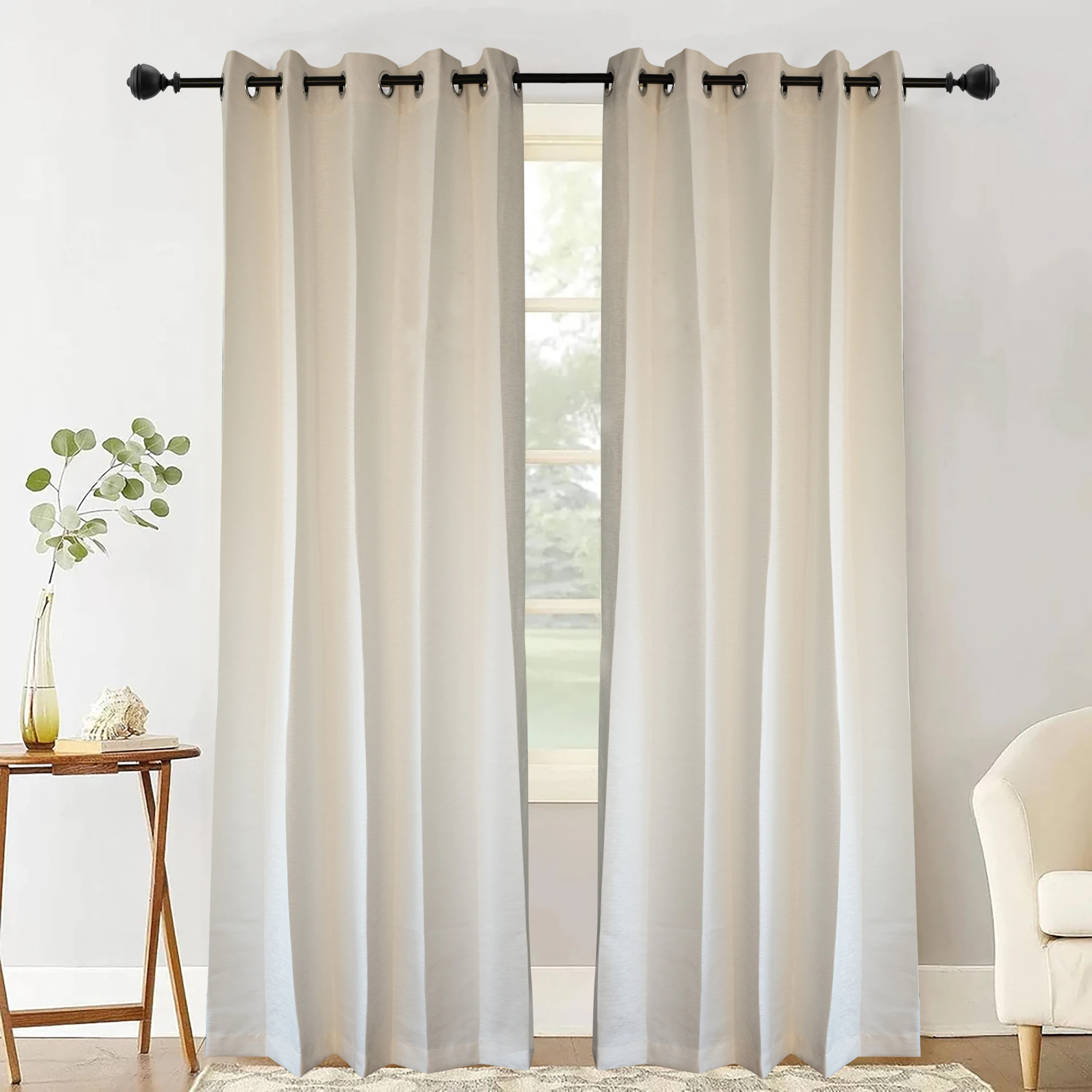 Cream-colored curtains hang from a black rod.