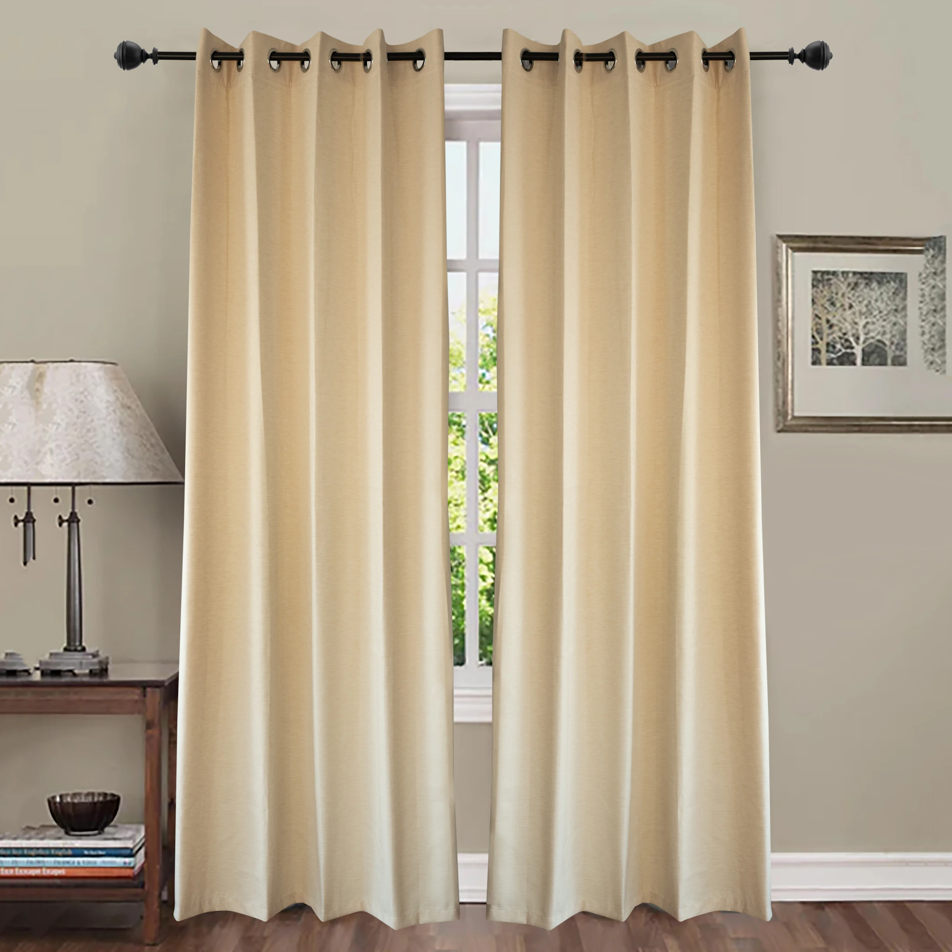 Cream colored curtains hang over a window