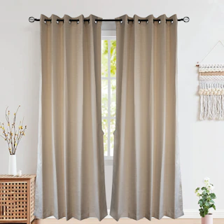 Beige curtains hanging on a window with natural light