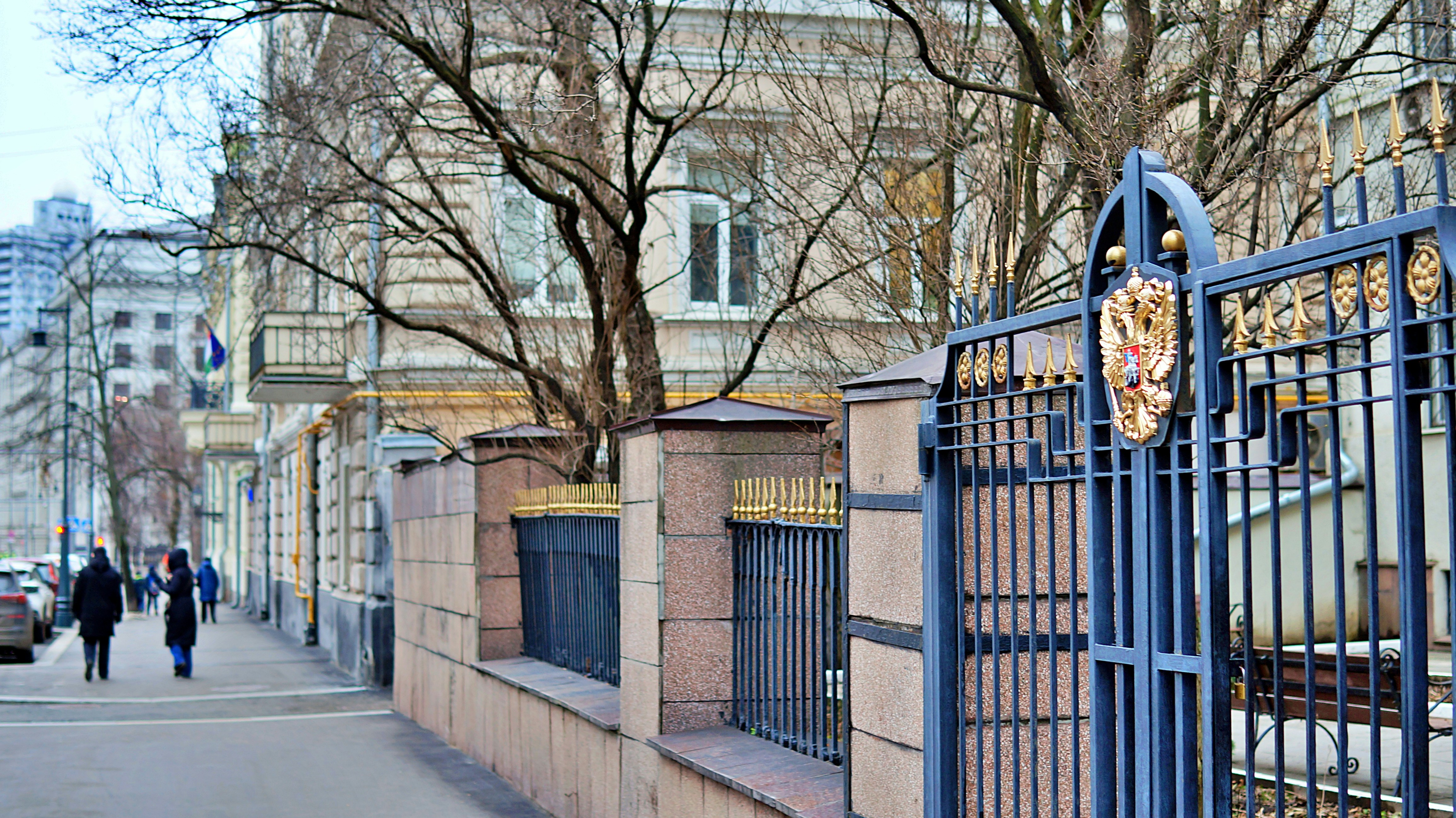 Ornate gate and building exterior on a city street.