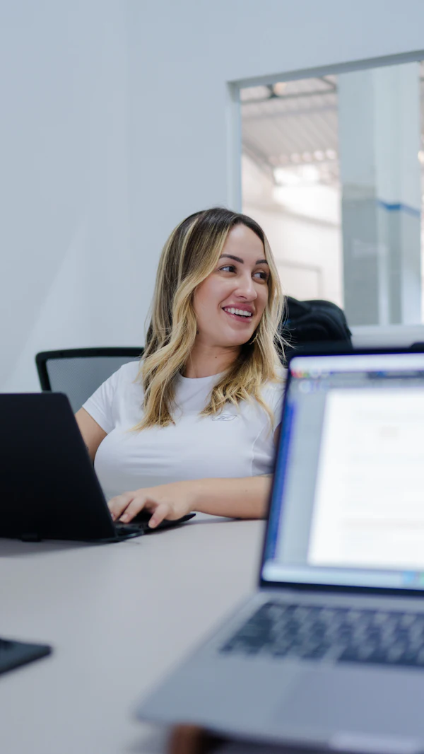 Woman smiling while working on her laptop