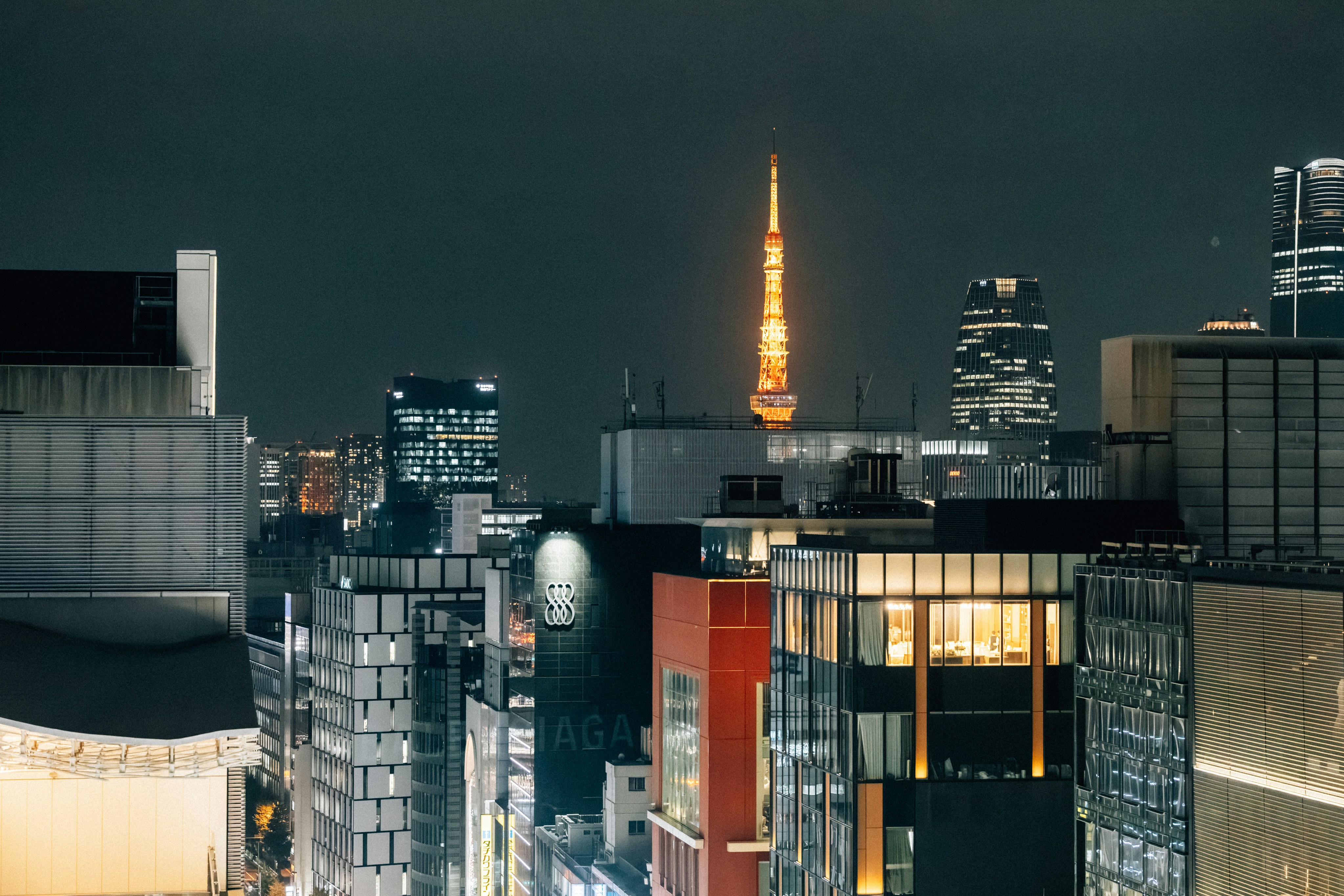 Cityscape with illuminated tower at night