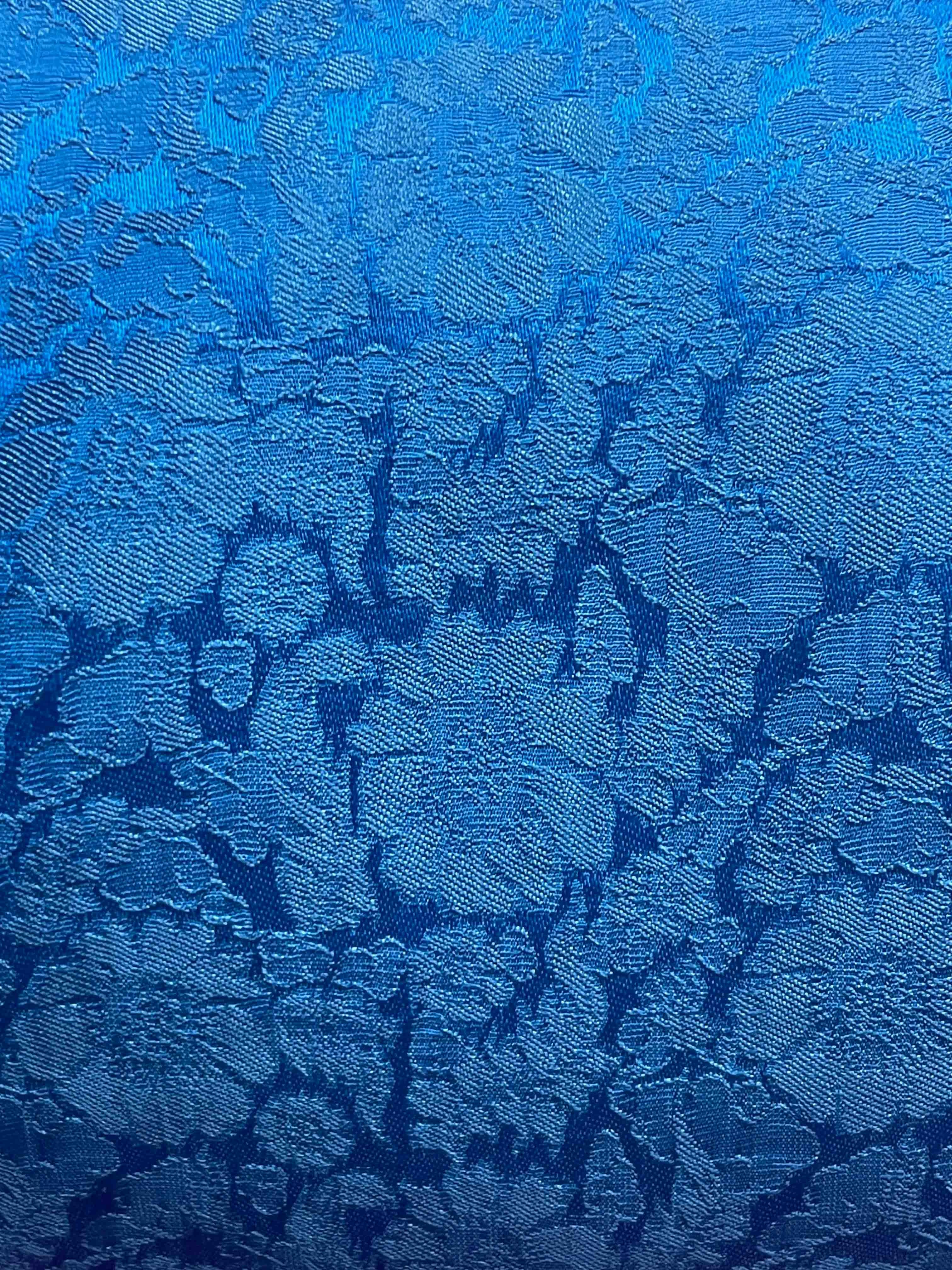 Blue floral textured fabric with gradient