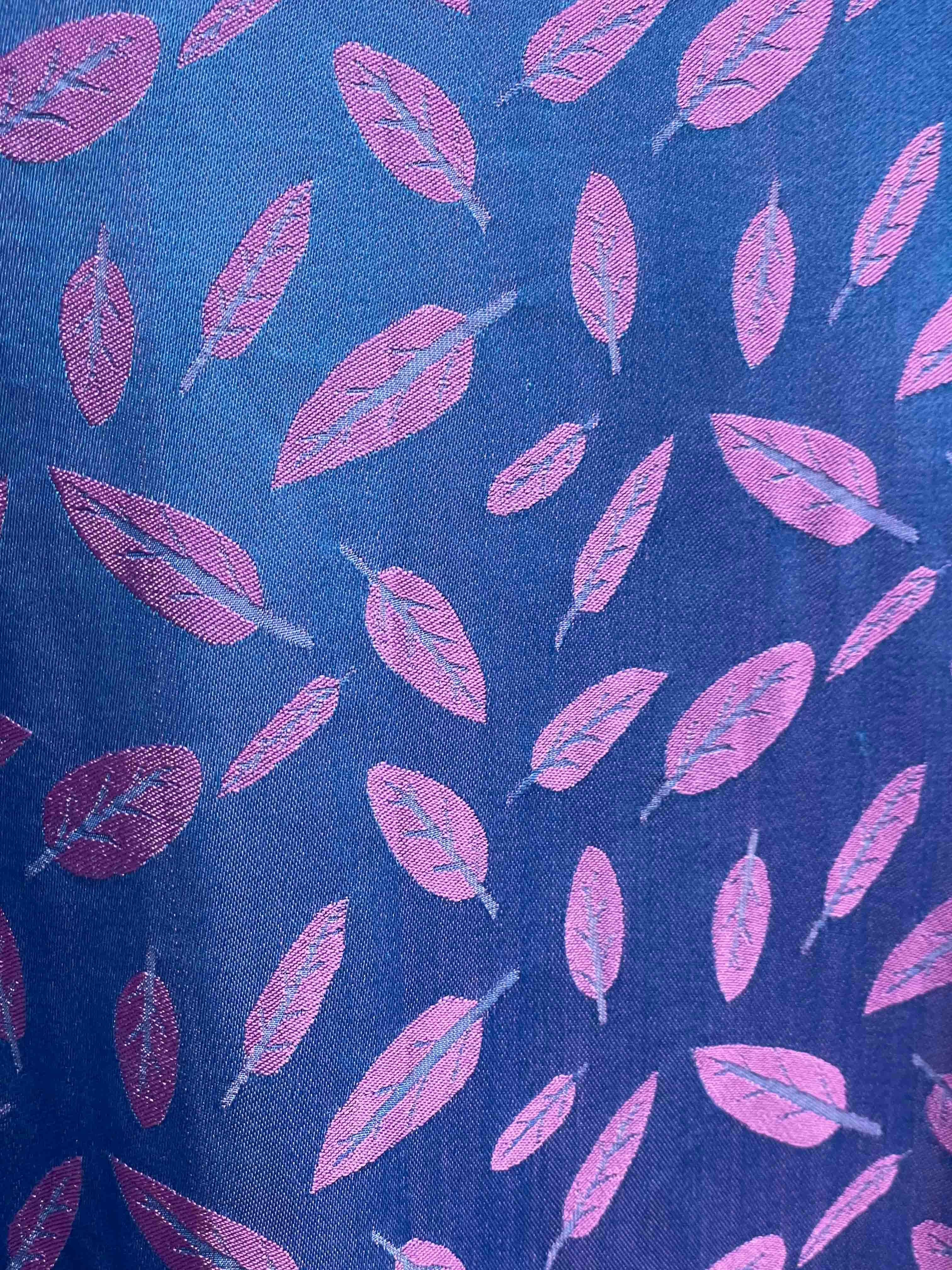 Pink feathers scattered on a blue background