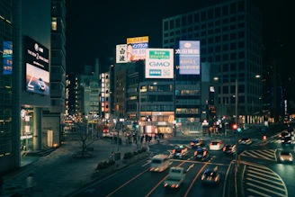 Busy city street at night with glowing billboards