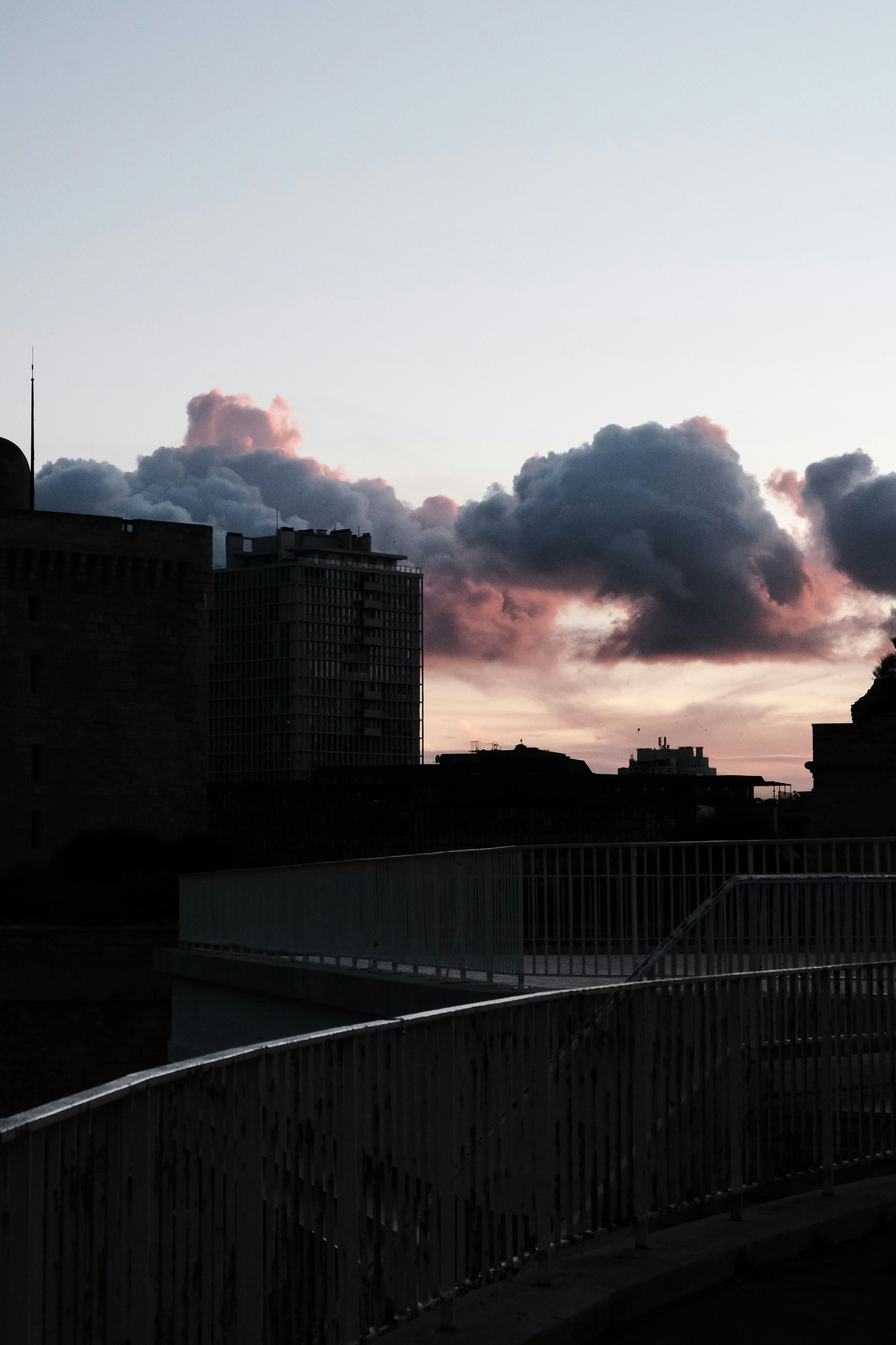 City skyline with dramatic clouds at sunset