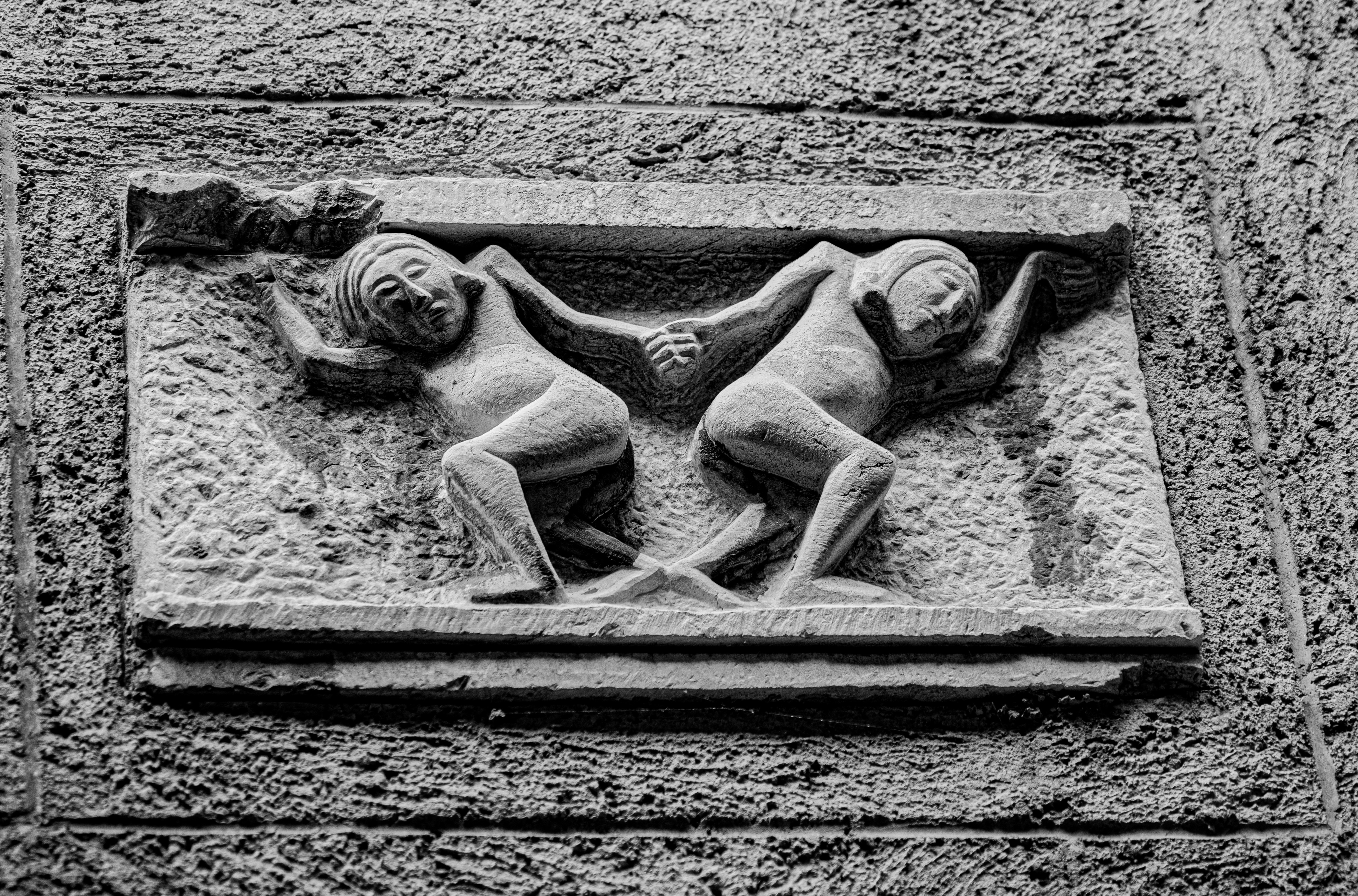 Two figures carved in stone supporting a heavy load.