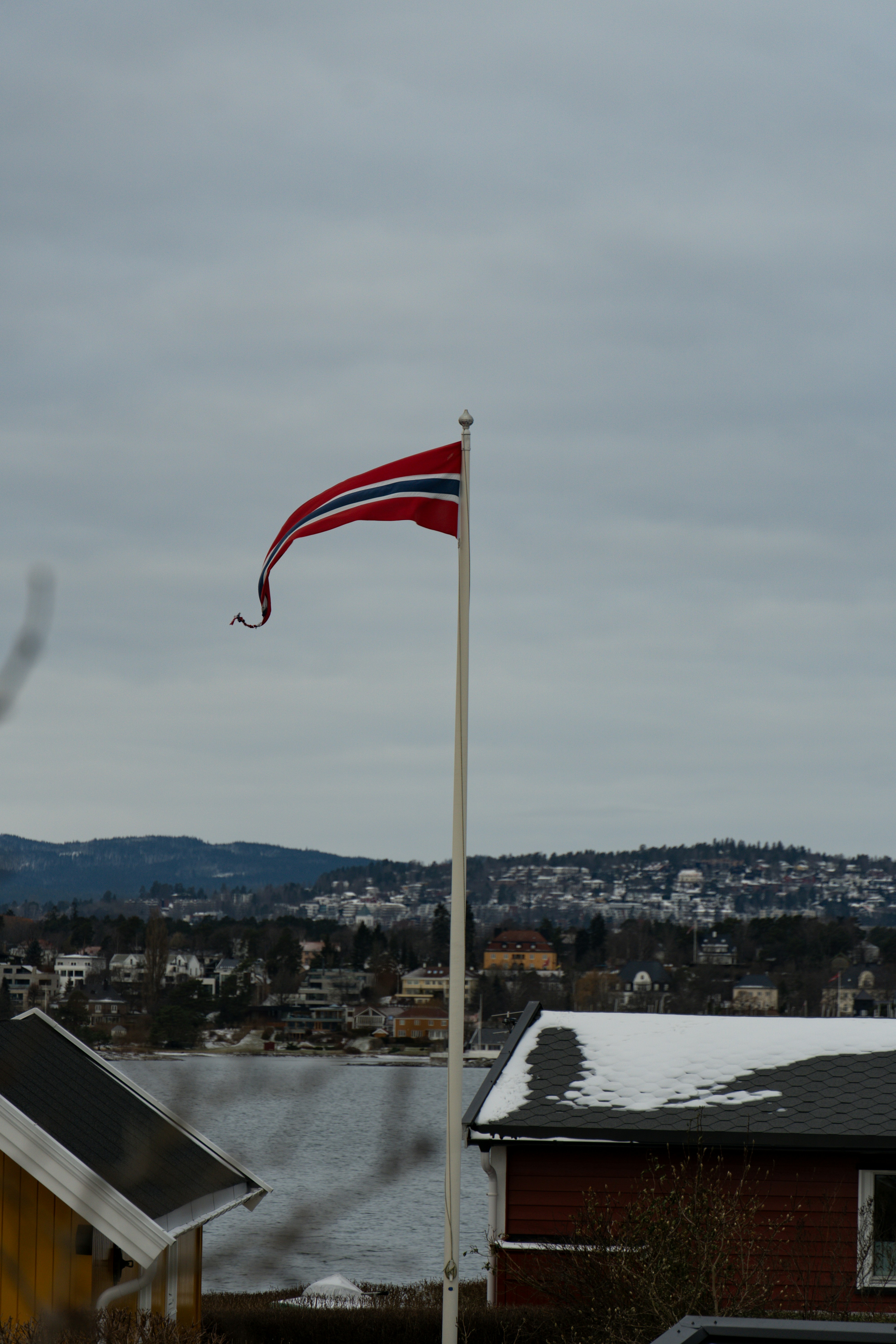 Norwegian flag flying against a cloudy sky