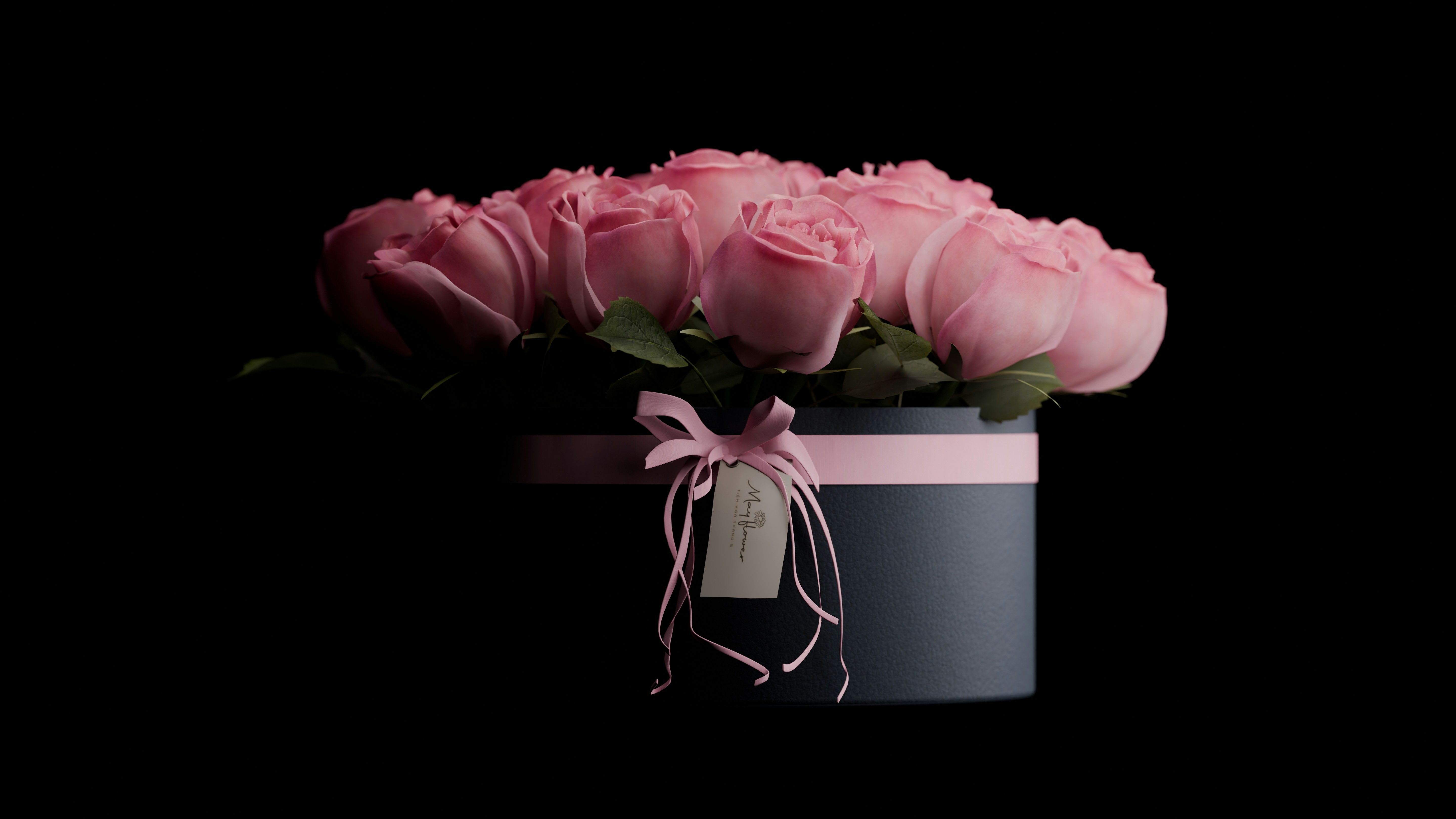 A bouquet of pink roses in a dark box