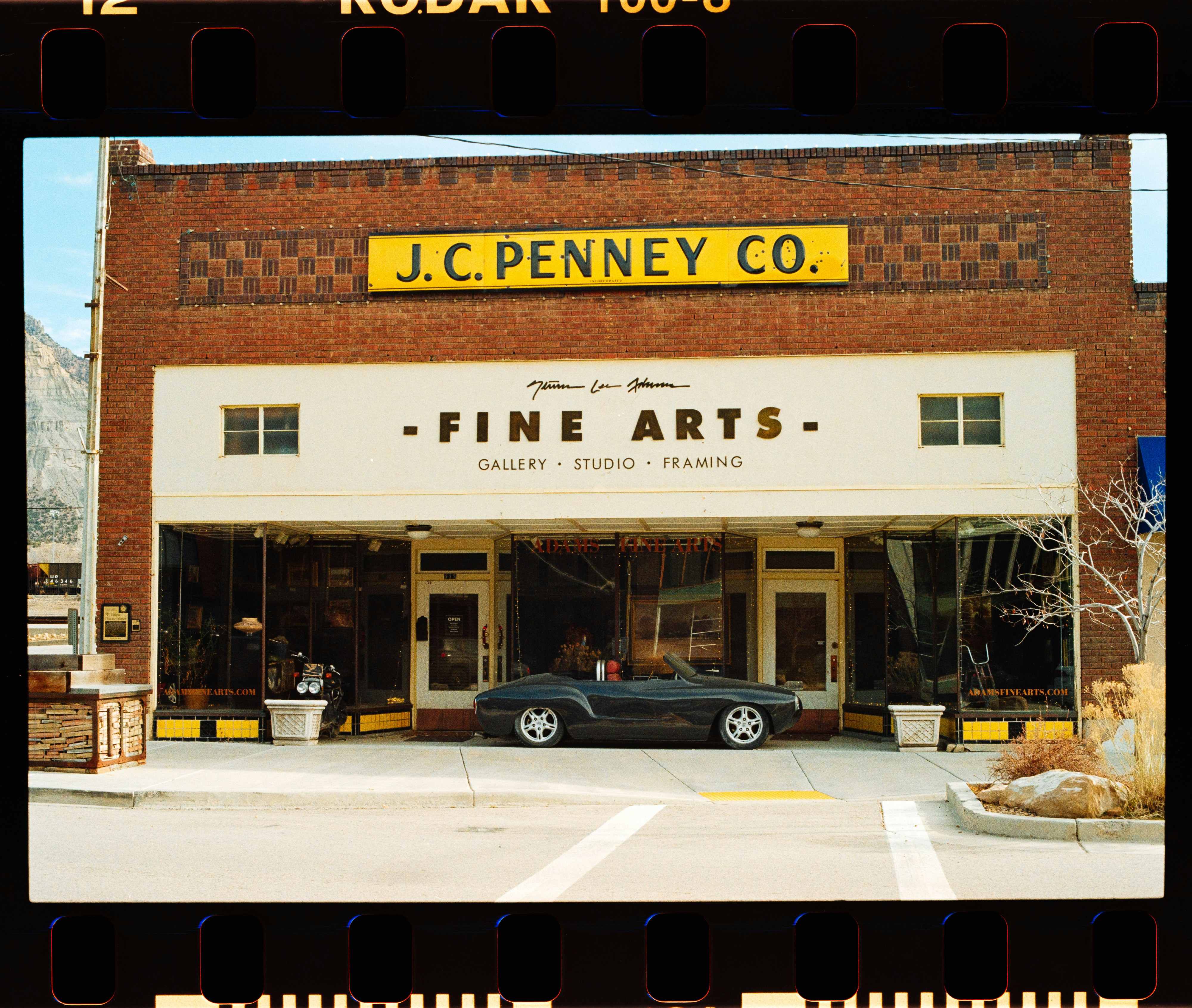J.c. penney co. fine arts store with convertible car.