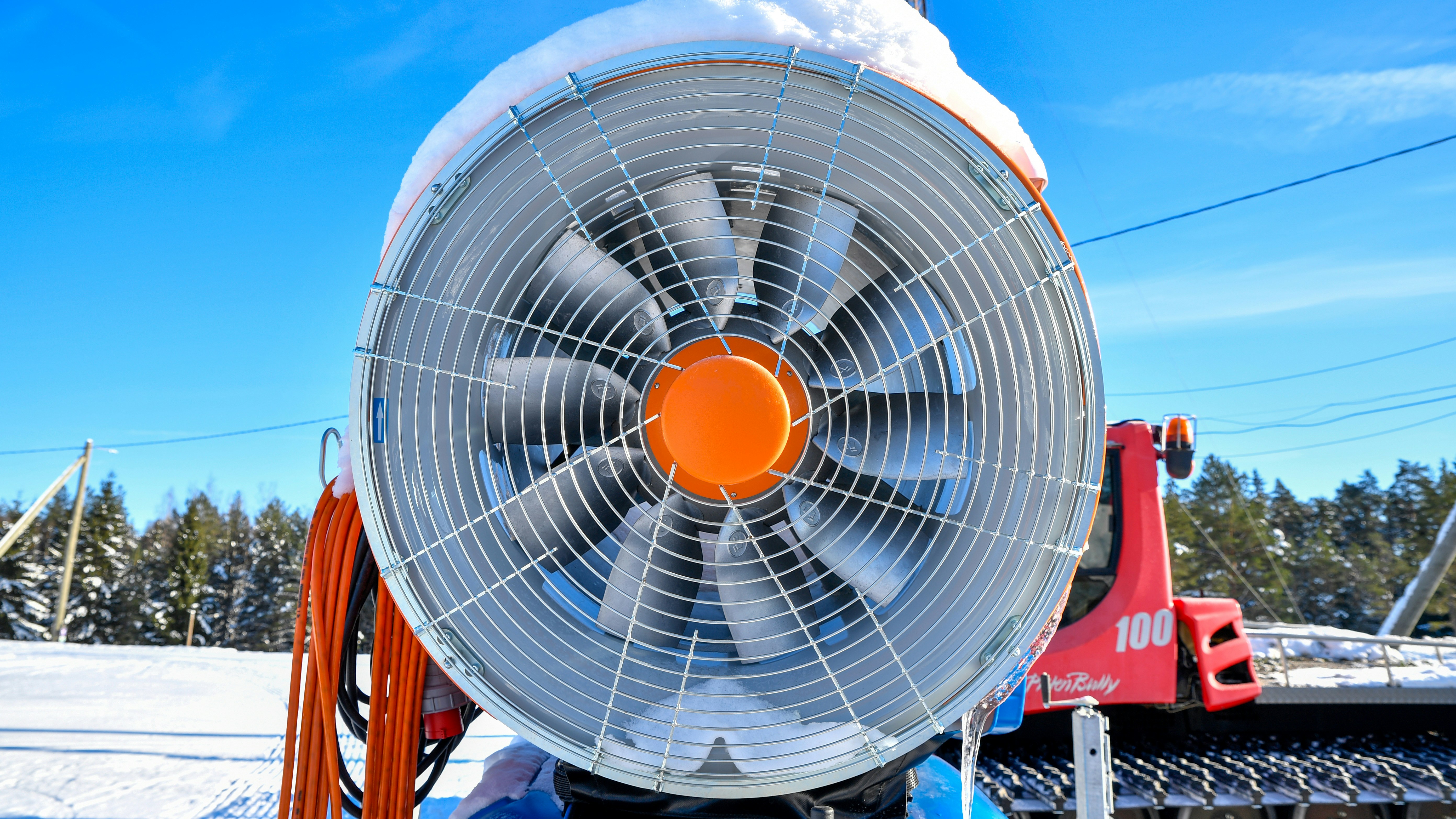 A snow cannon machine with a large fan