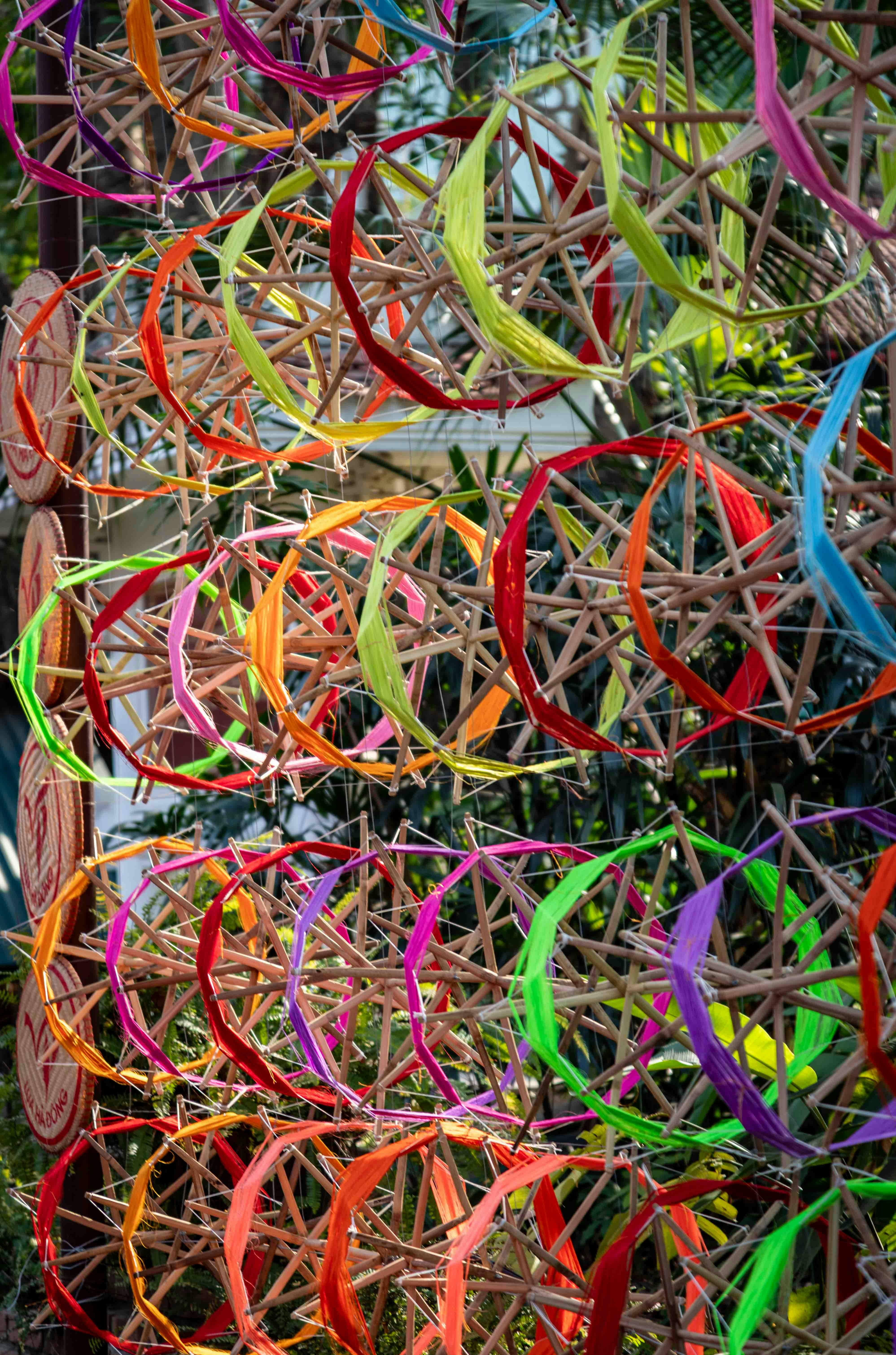 Colorful woven wheels hanging outdoors