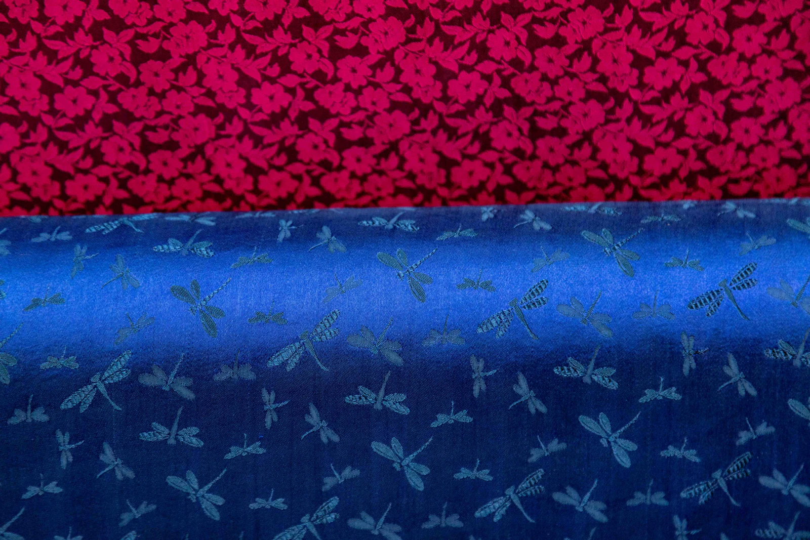 Two printed fabric patterns in floral and insect motifs