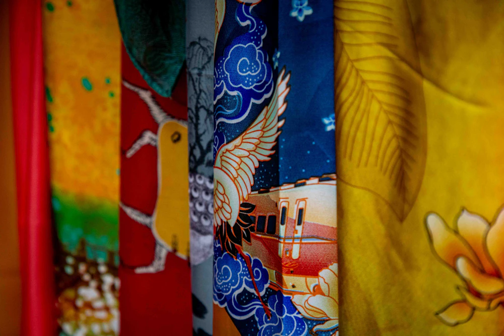 Hand-painted silk panels patterned with cranes flowers and indigo clouds
