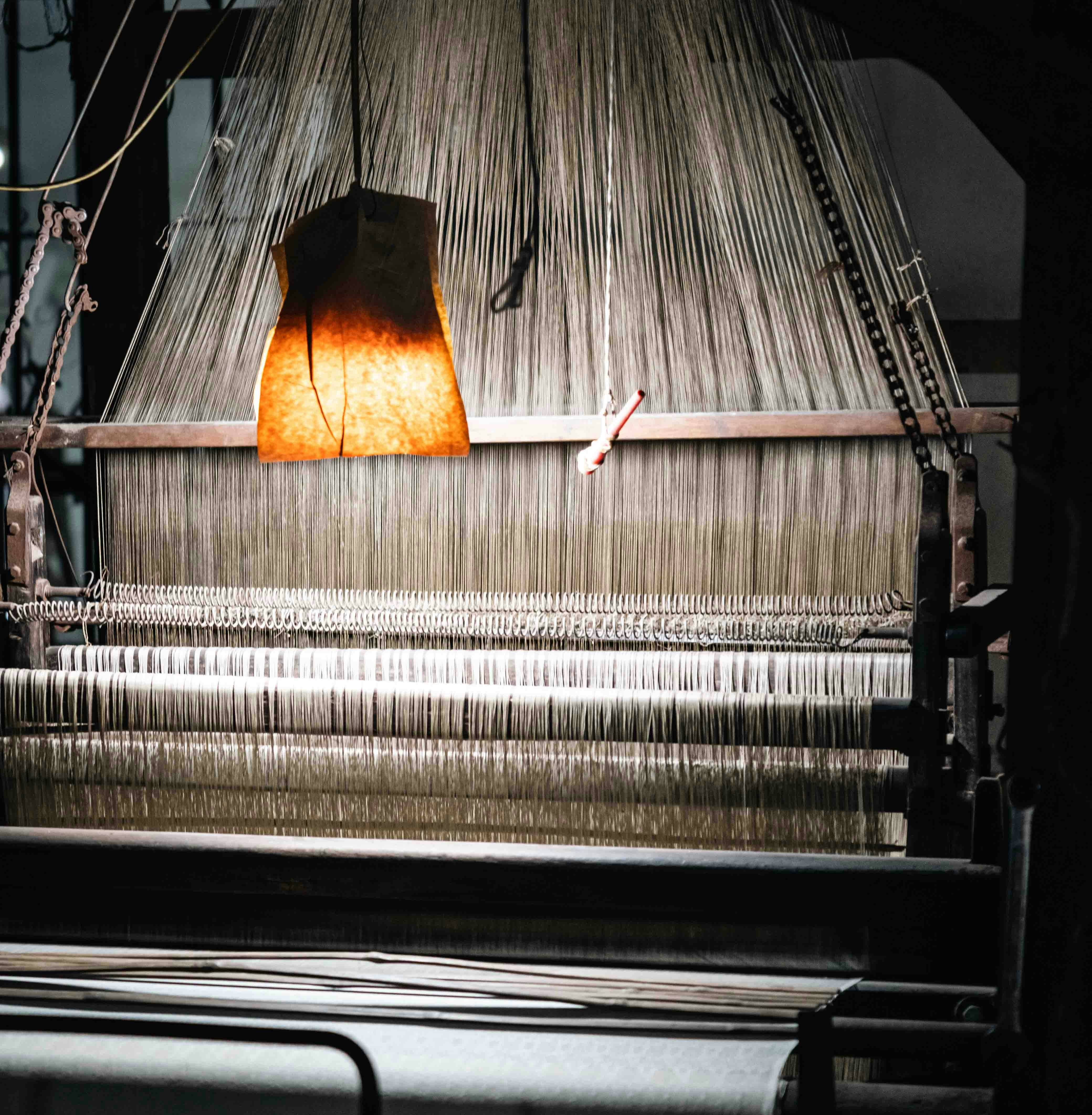 Close-up of an old loom with many threads.