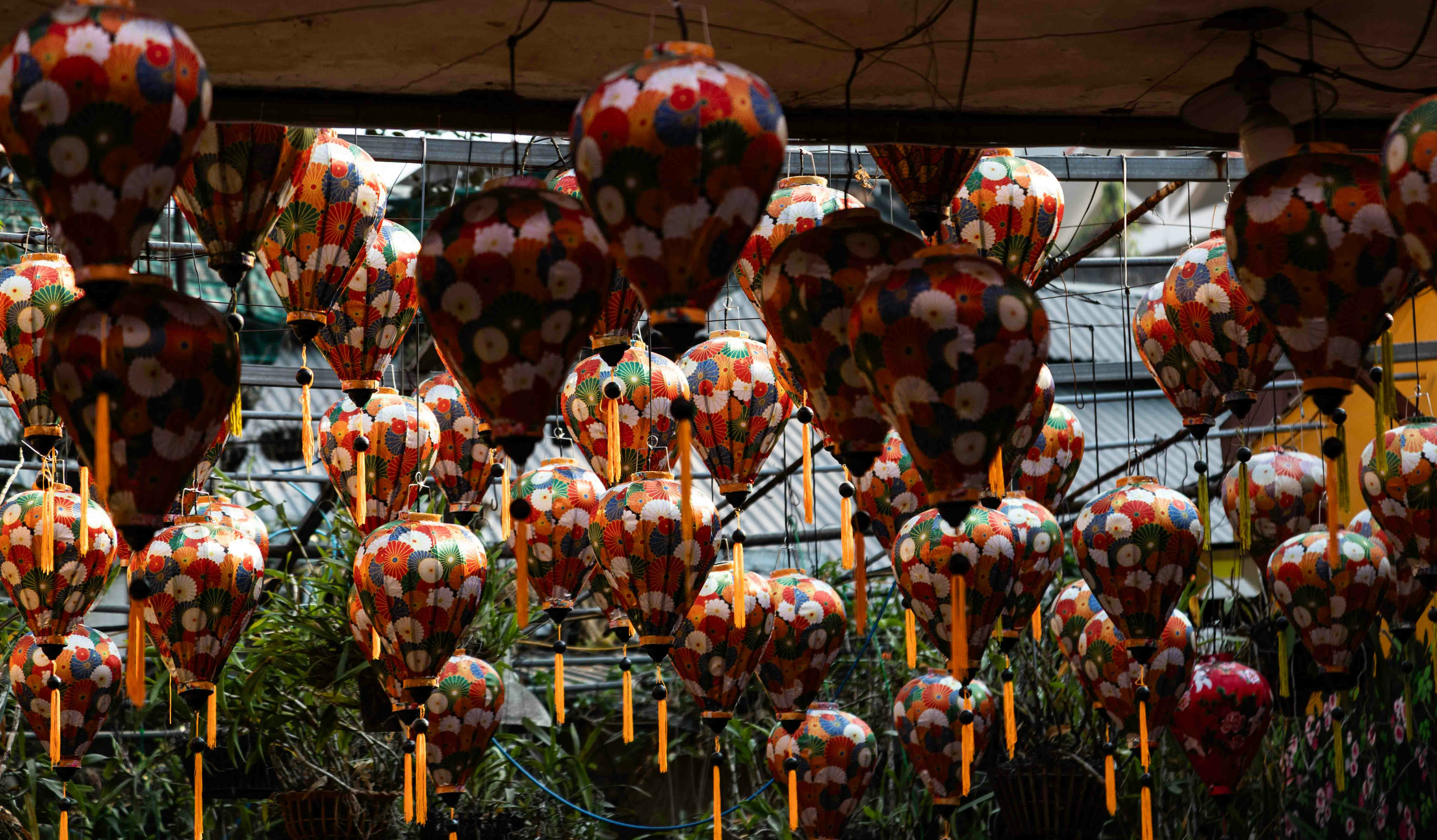 Many decorative lanterns hanging from ceiling
