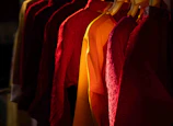 Row of colorful shirts hanging on a rack