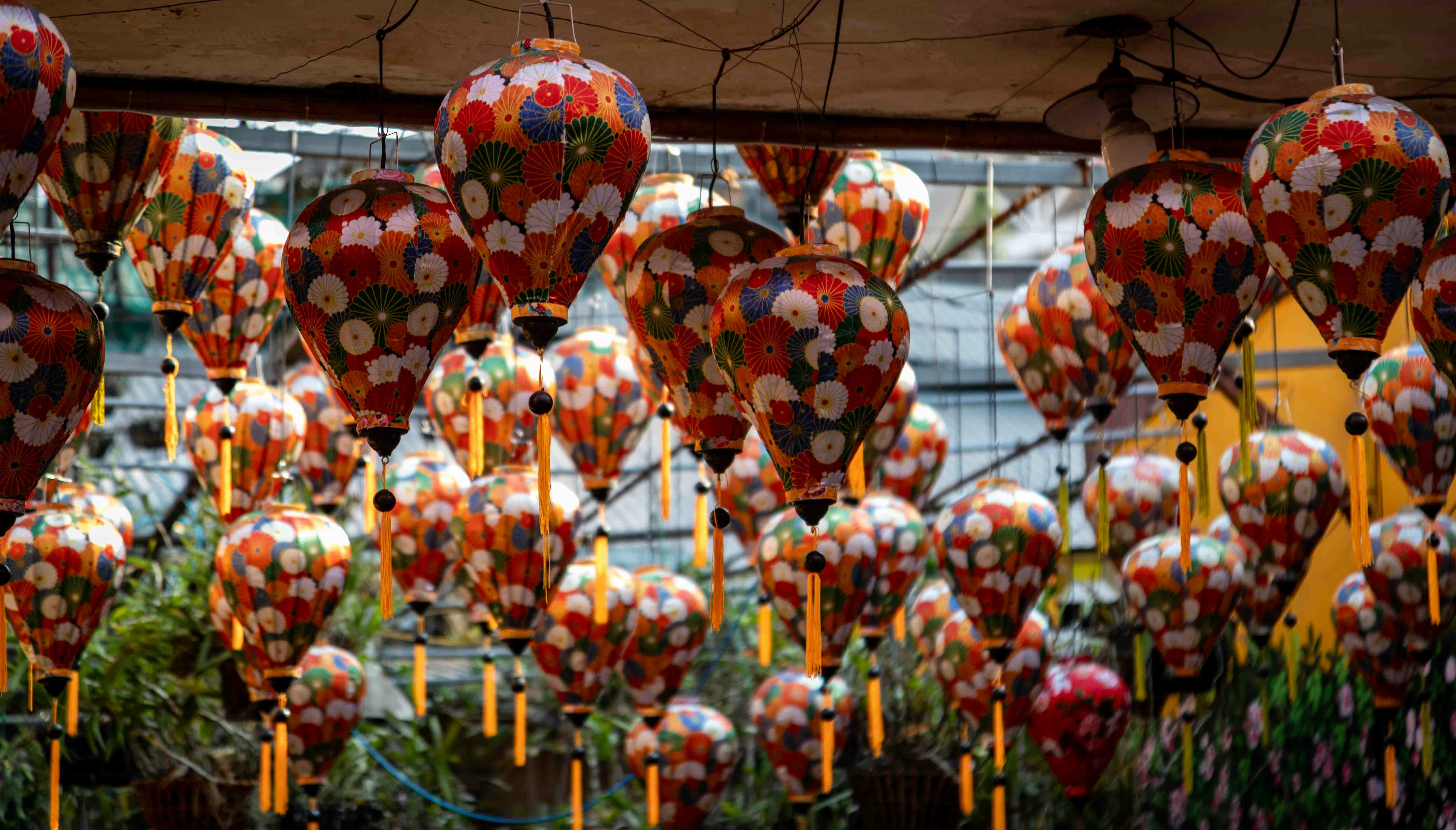 Colorful patterned lanterns hanging outdoors