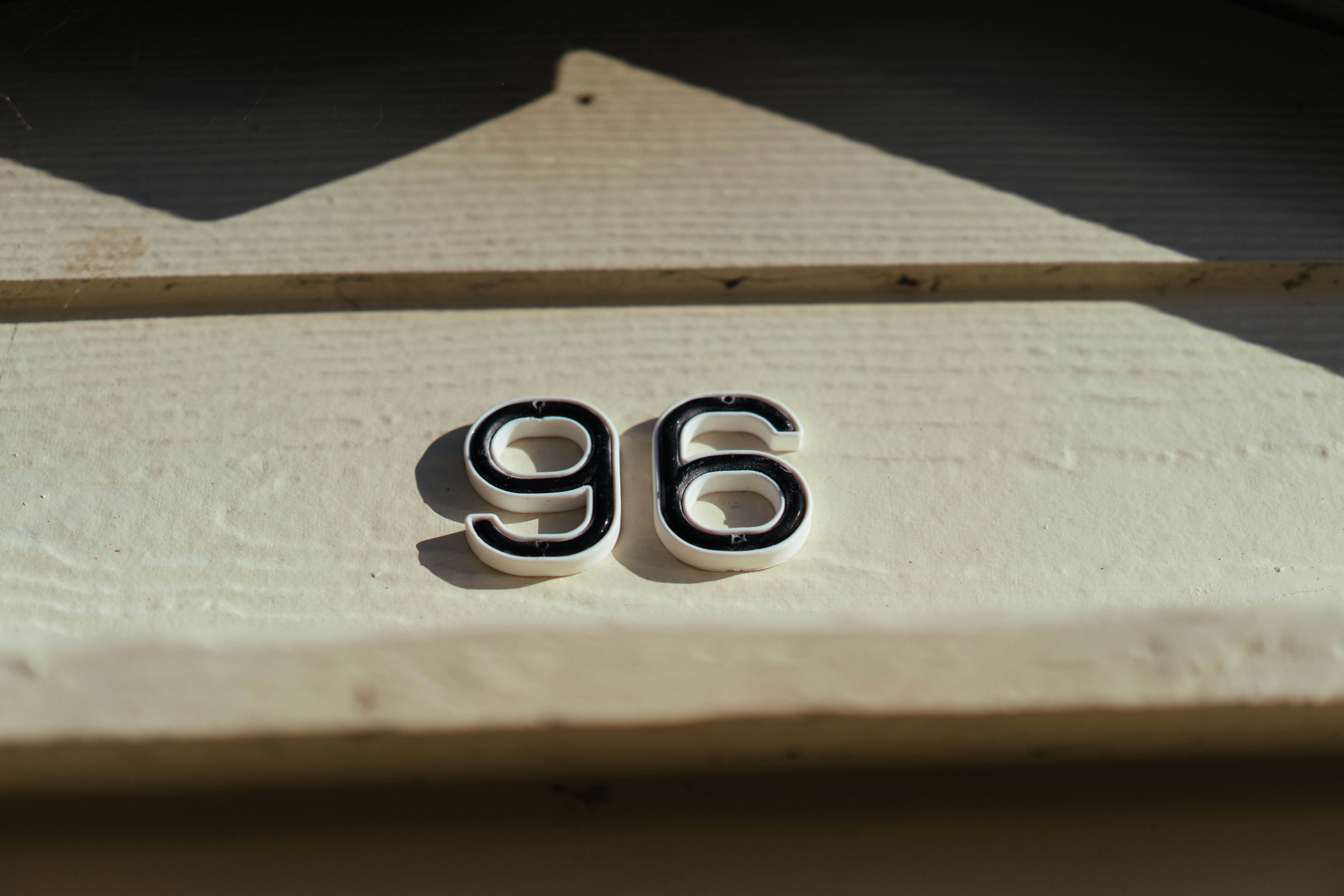 The numbers 96 on a light-colored surface.