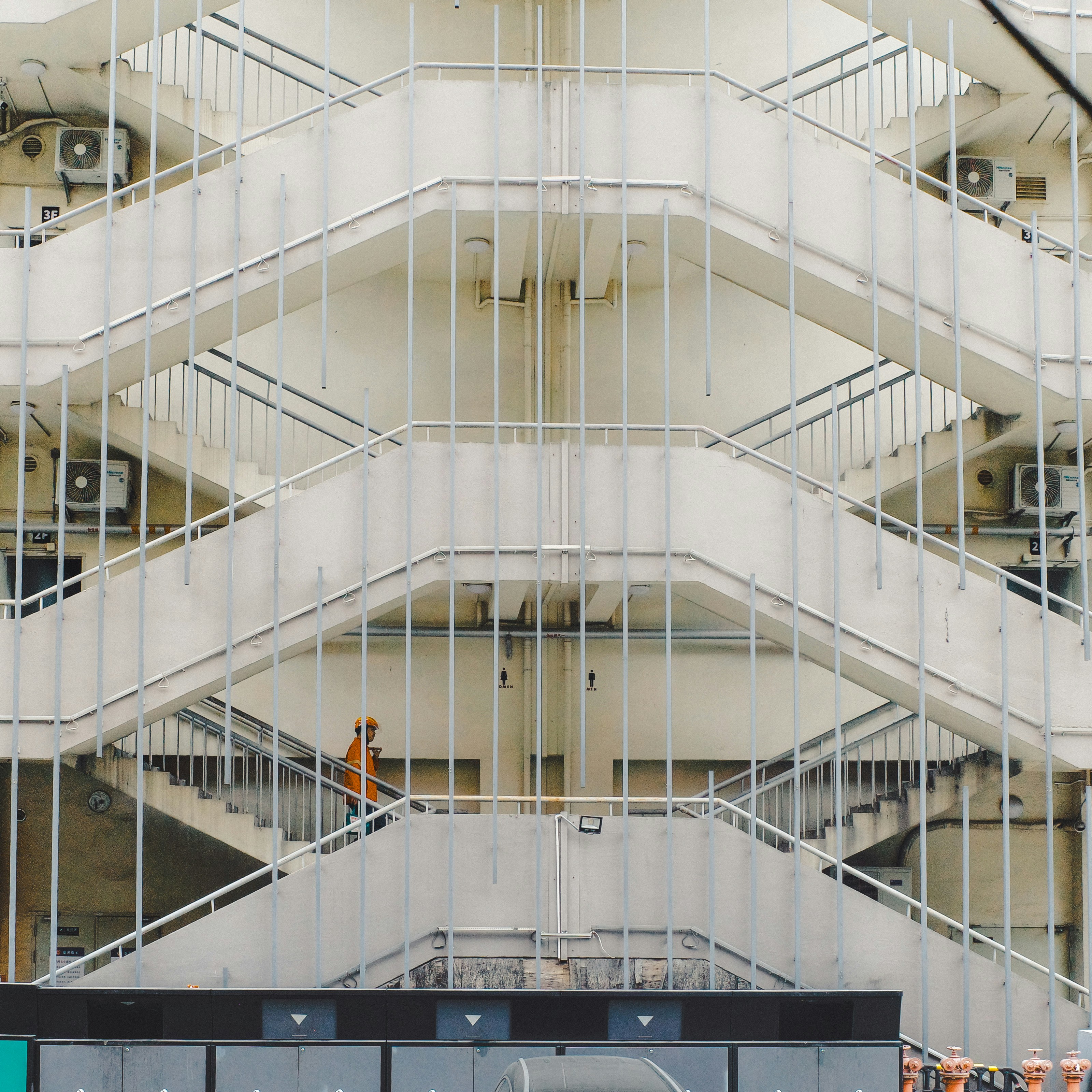 A person walks up a concrete outdoor staircase