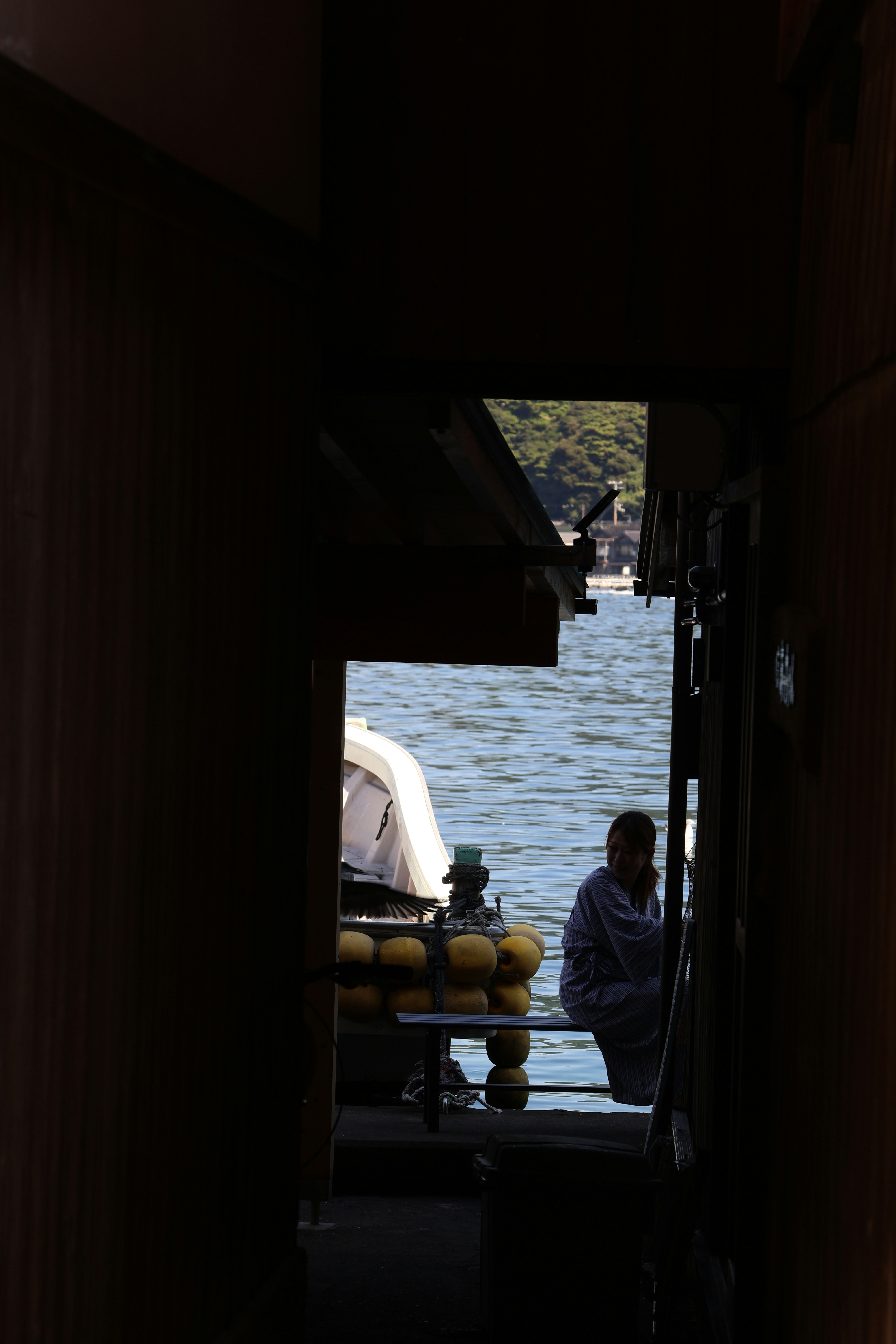 Person sitting on a boat by the water.