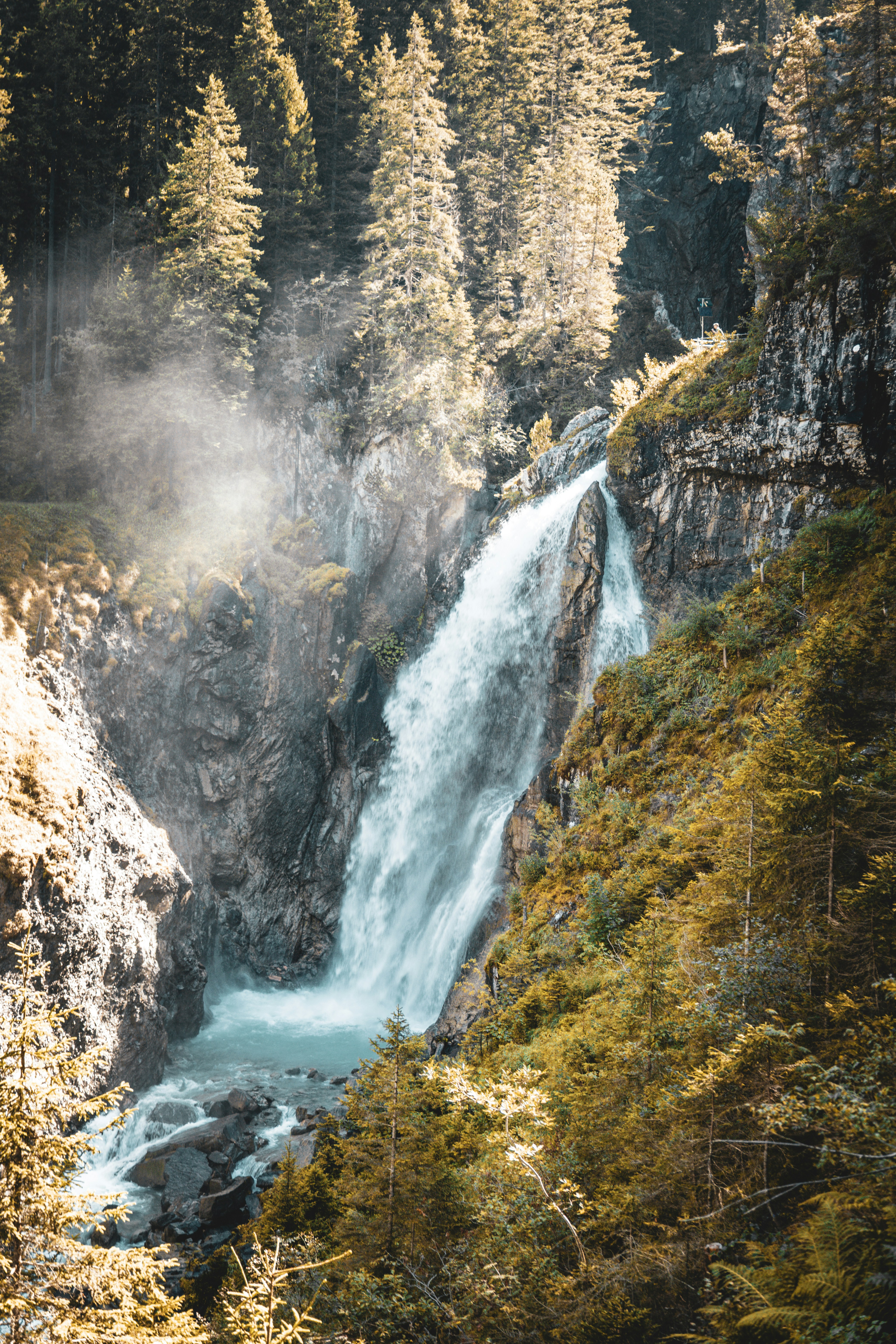 A powerful waterfall cascades down a rocky gorge.