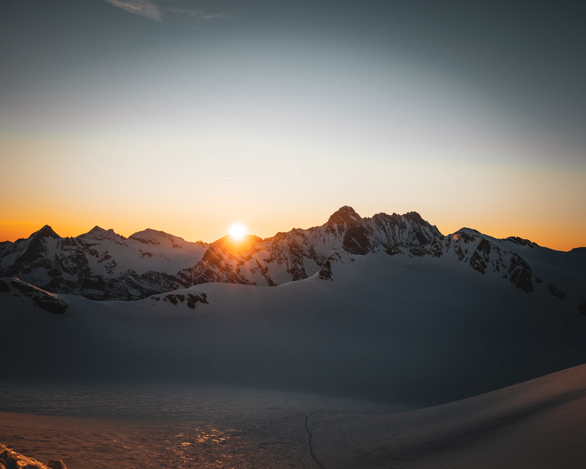 Sunrise over a snow covered mountain range