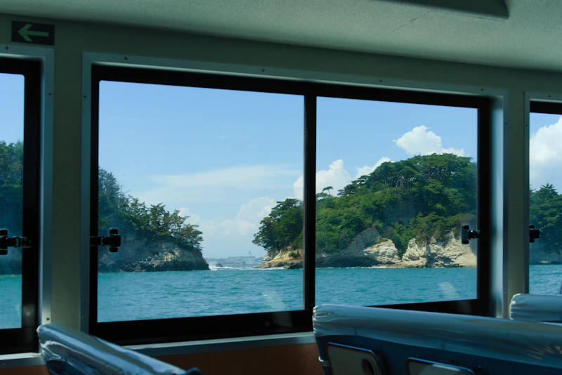 A ferry crossing Matsushima Bay with pine islands in the background