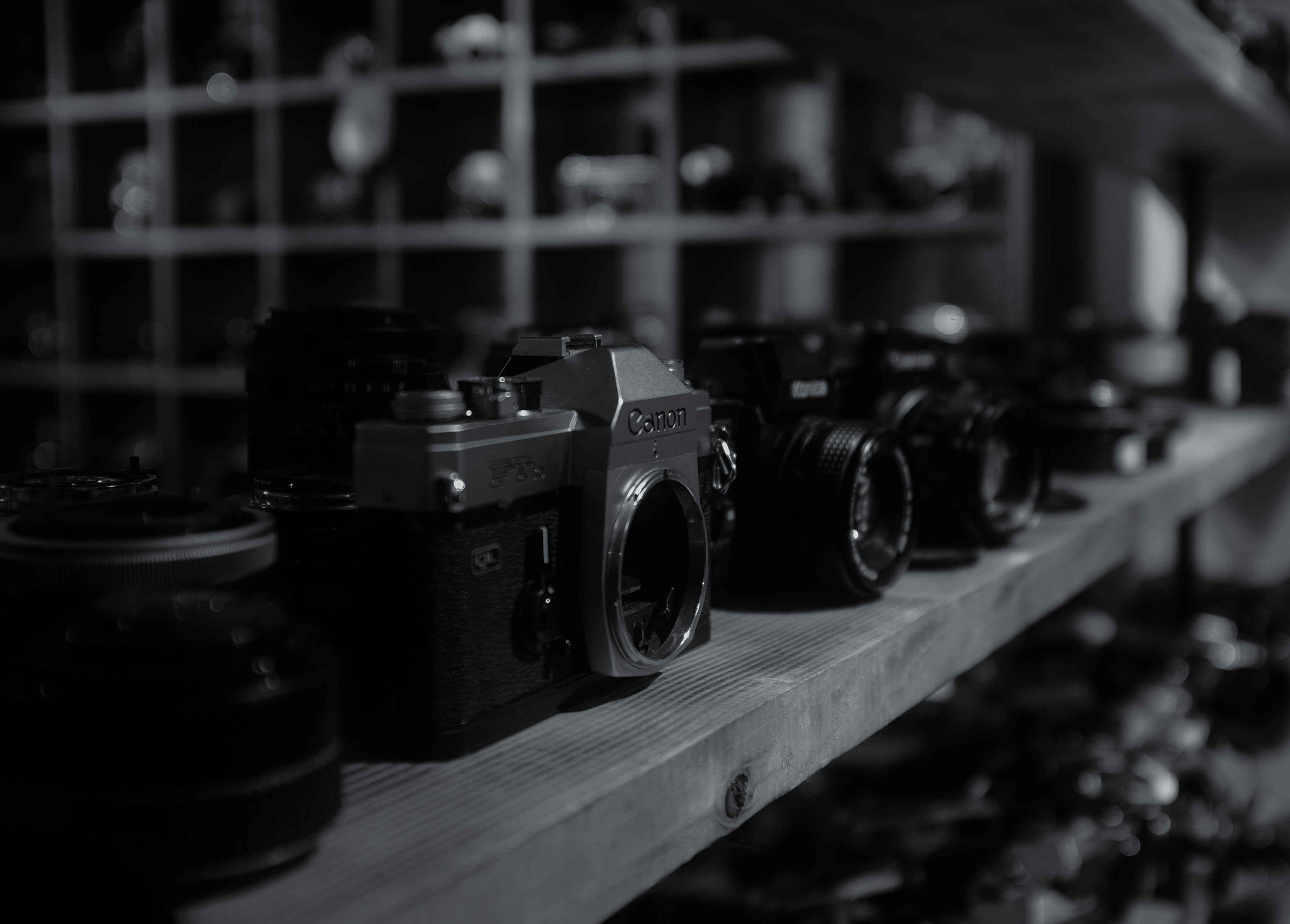 Several vintage cameras displayed on a shelf