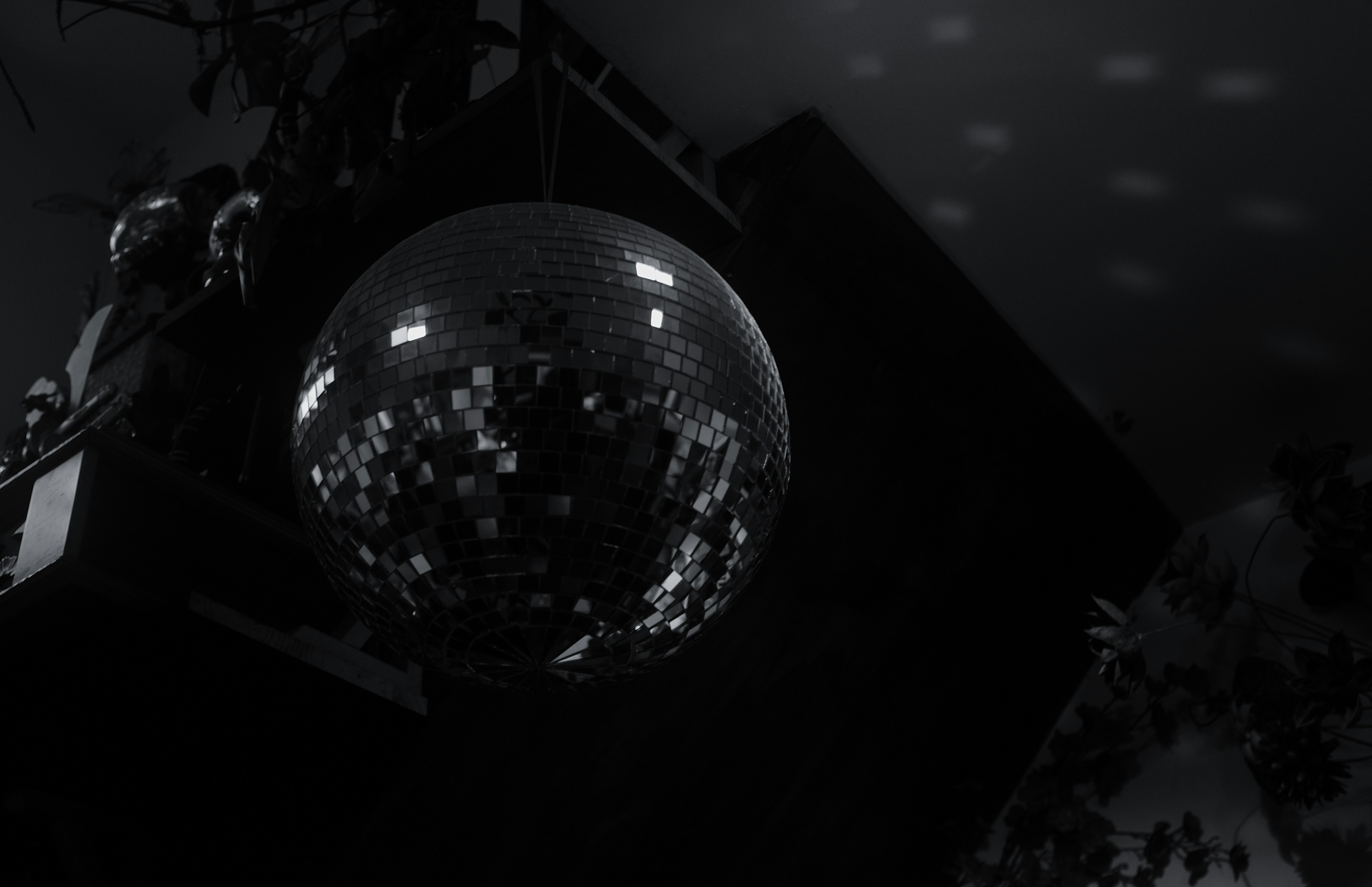 A disco ball hangs in a dark room