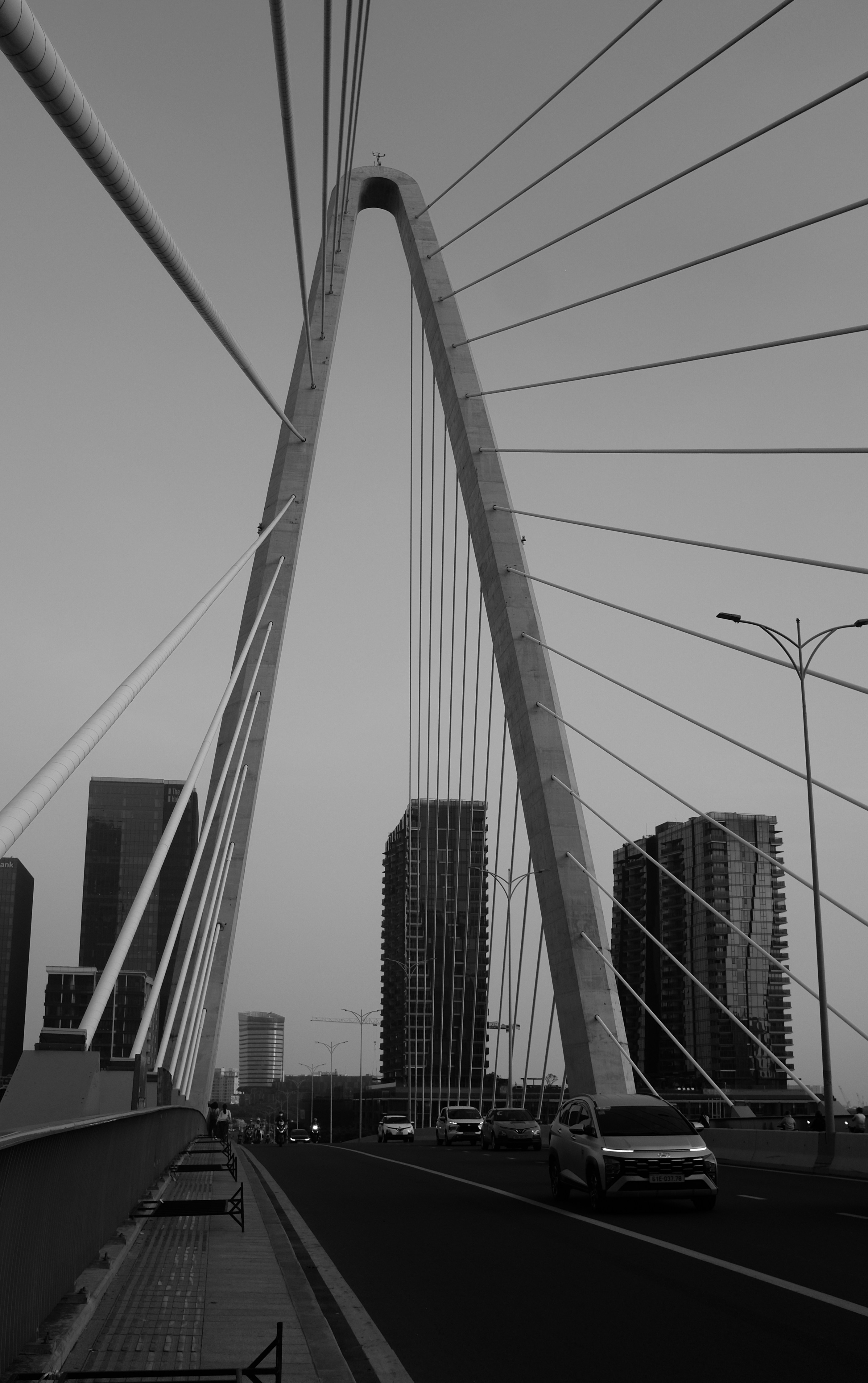 Modern cable-stayed bridge with city buildings in background