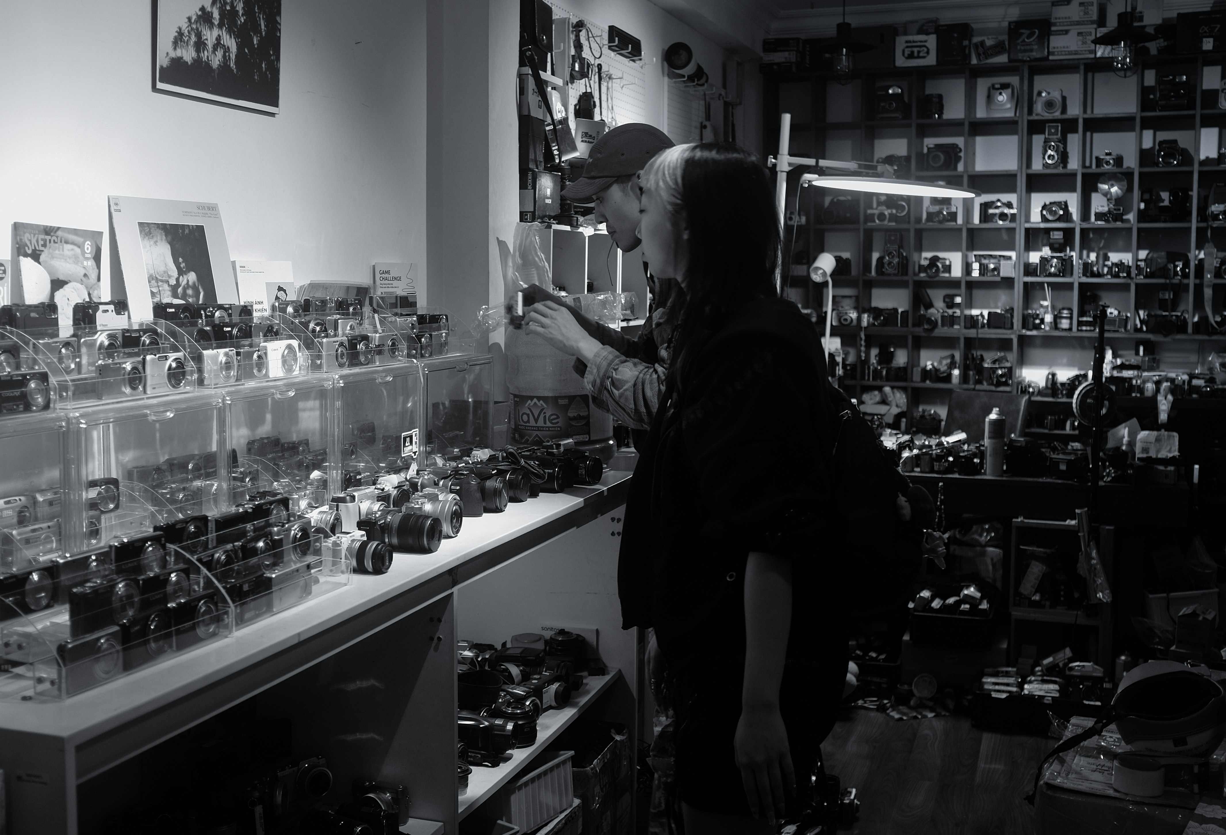 Two people examining items in a shop