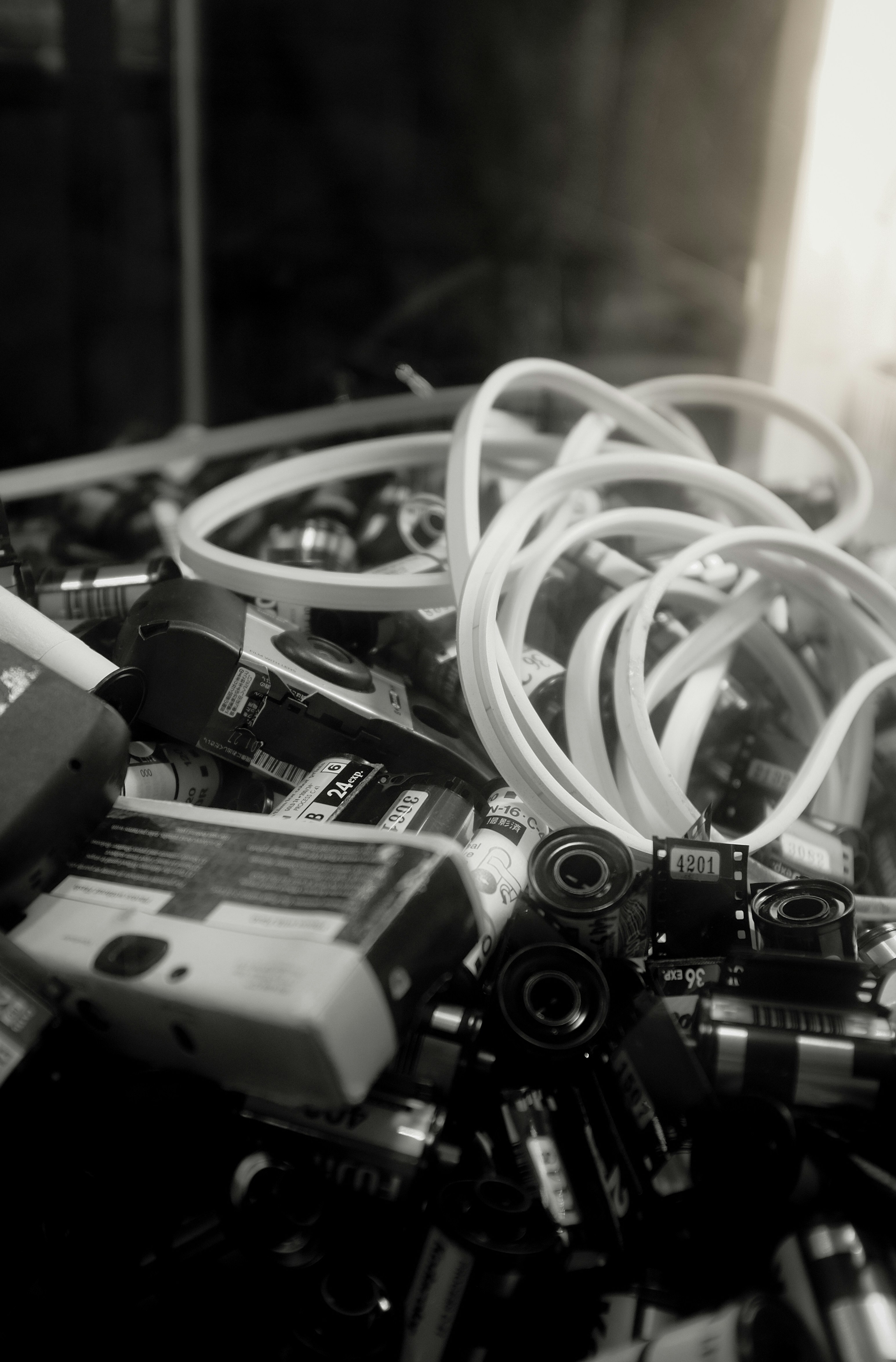 Pile of old cameras and film rolls