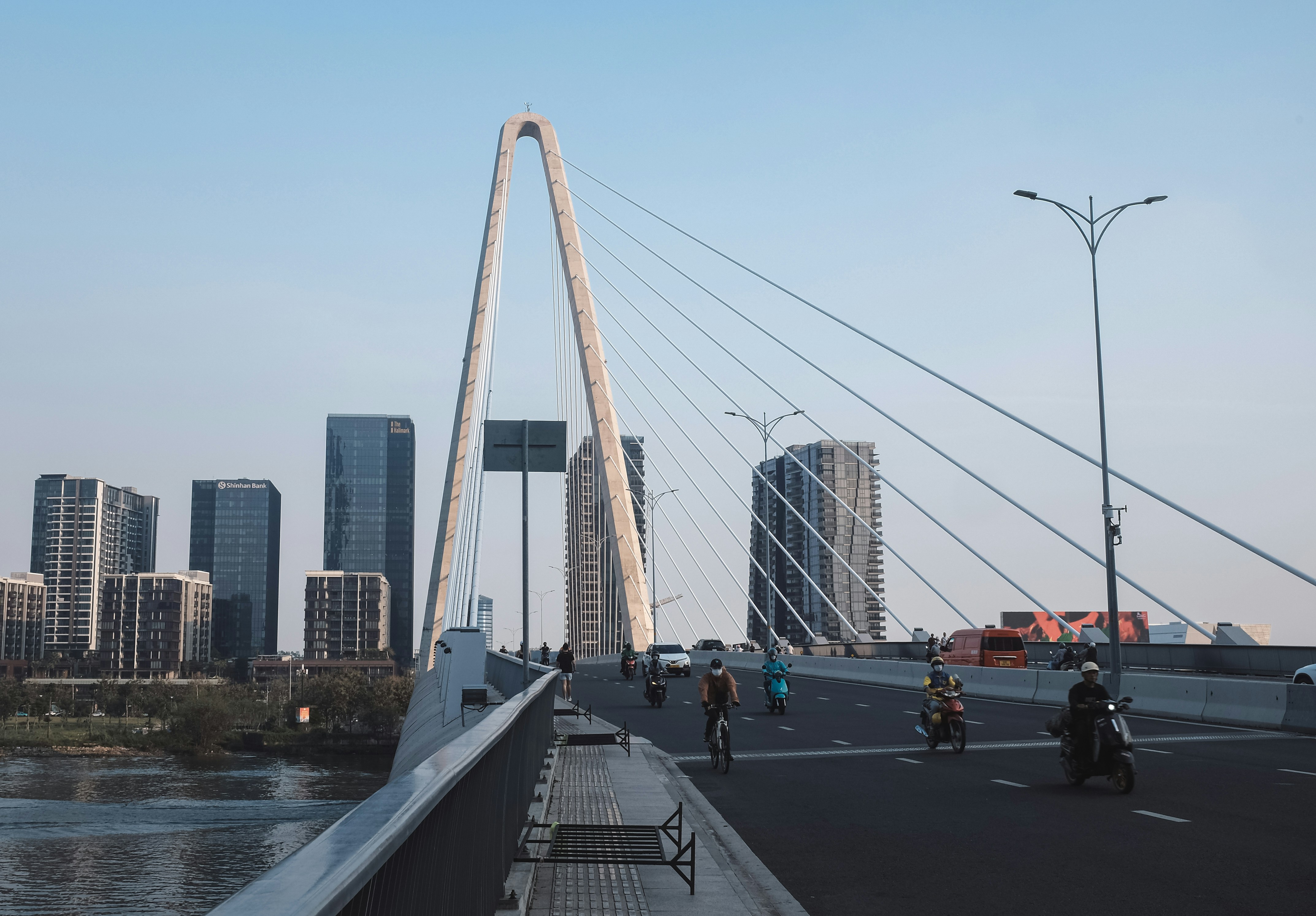 Modern cable-stayed bridge with city skyline background