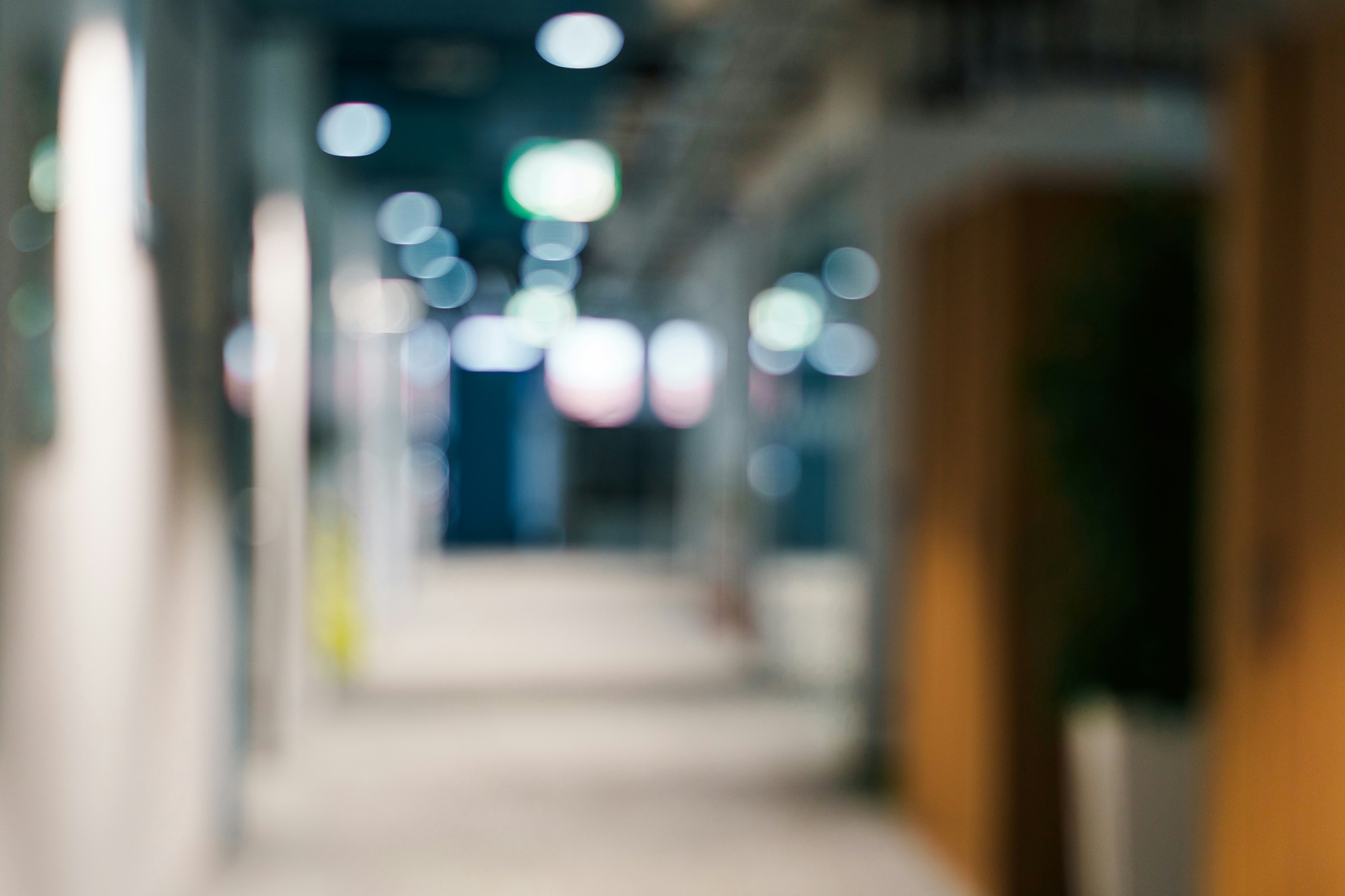 Blurred hallway with lights and wooden wall
