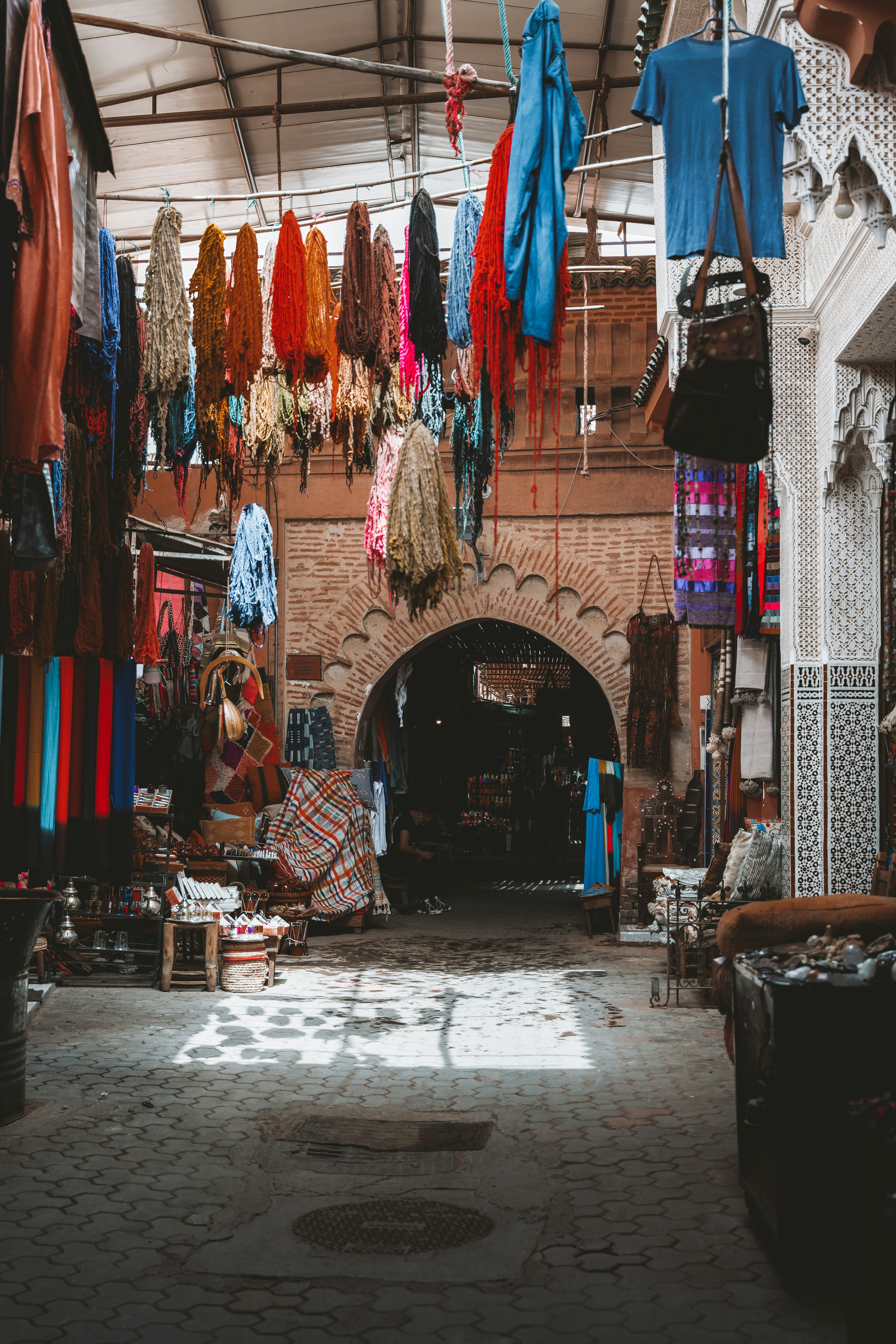 Colorful textiles and goods displayed in a moroccan market.