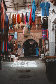 Colorful textiles and goods displayed in a moroccan market.