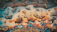 Colorful oil slick on water with textured surface