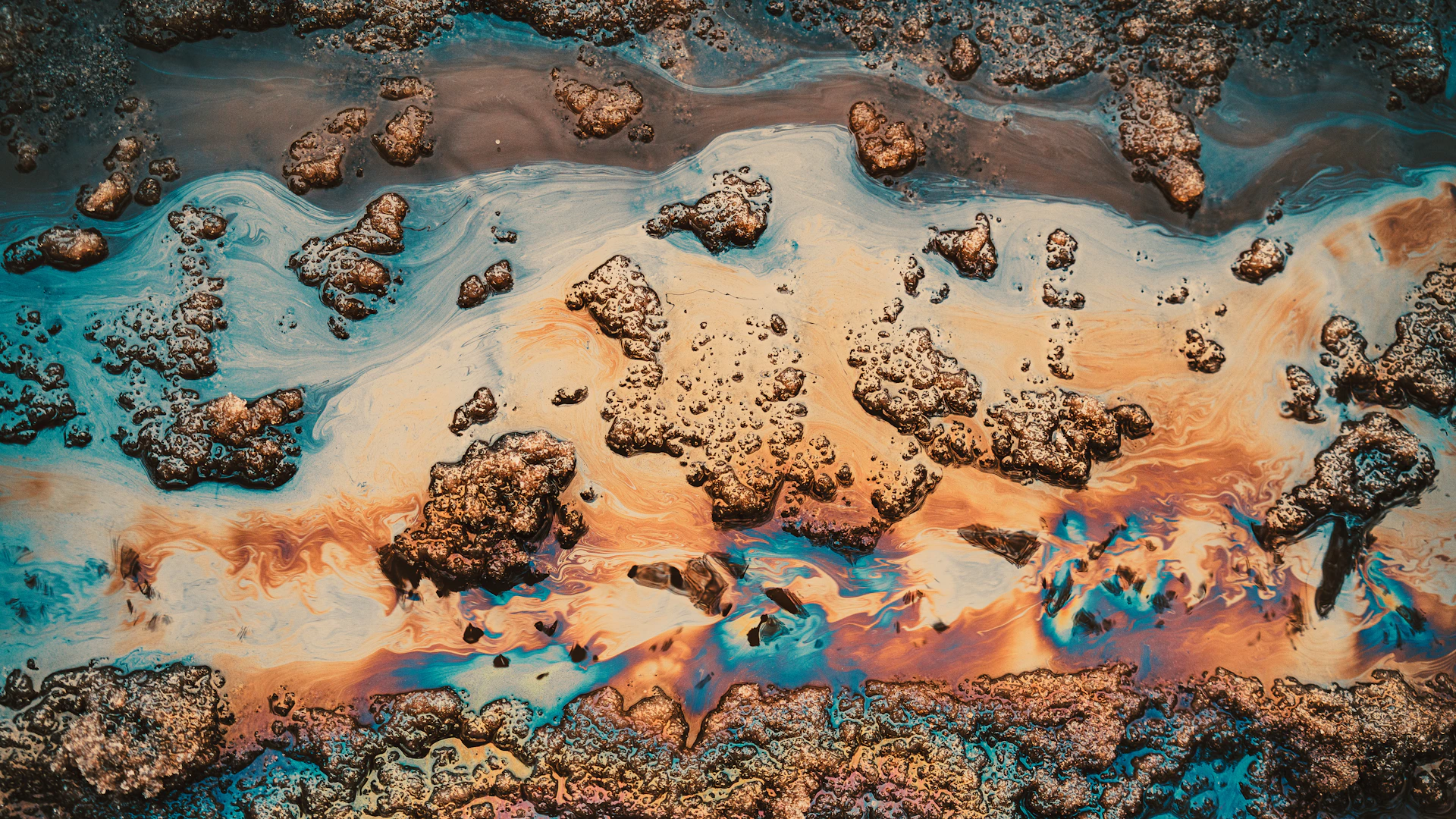 Colorful oil slick on water with textured surface