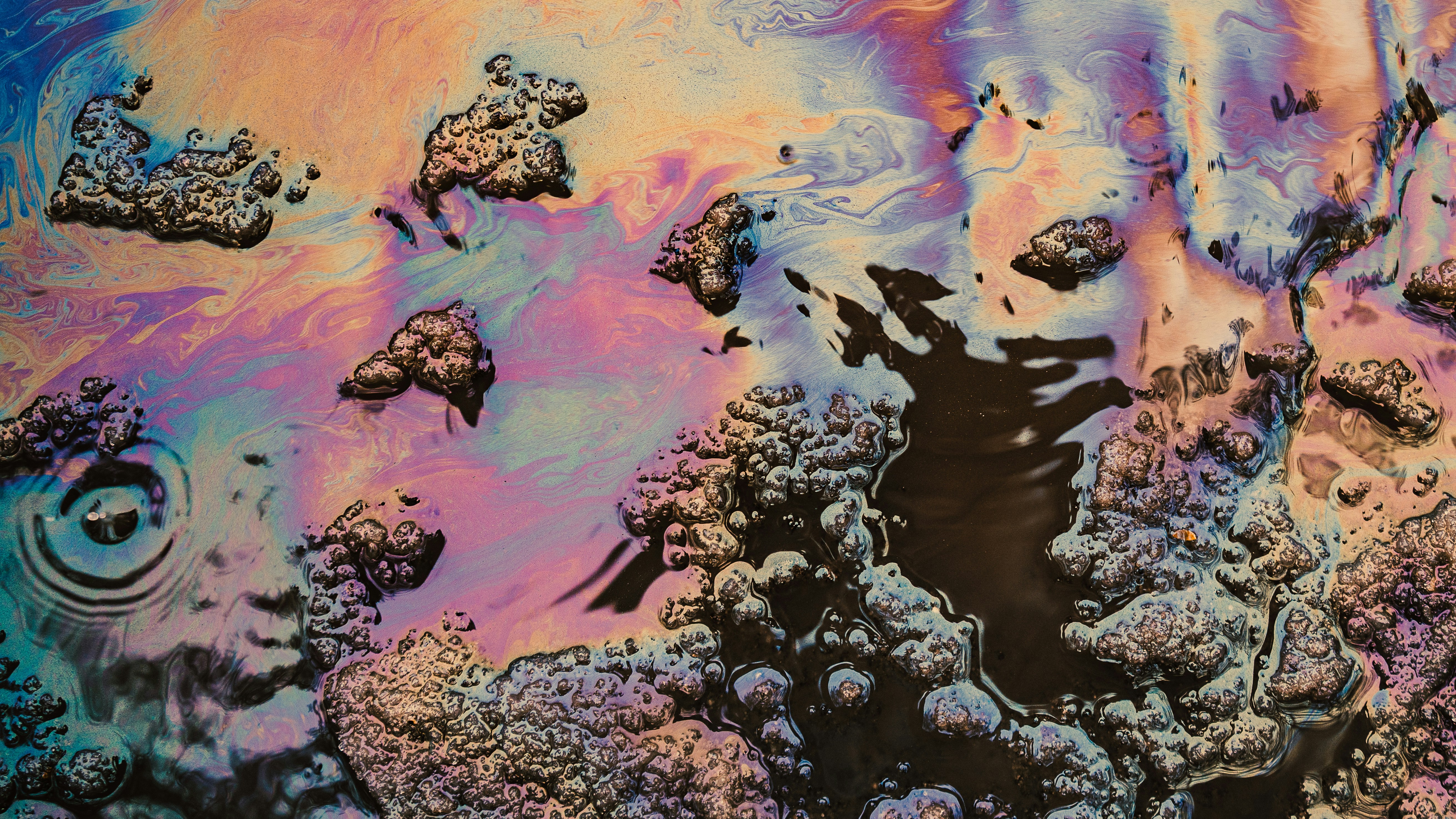 Iridescent oil slick with colorful patterns and textures