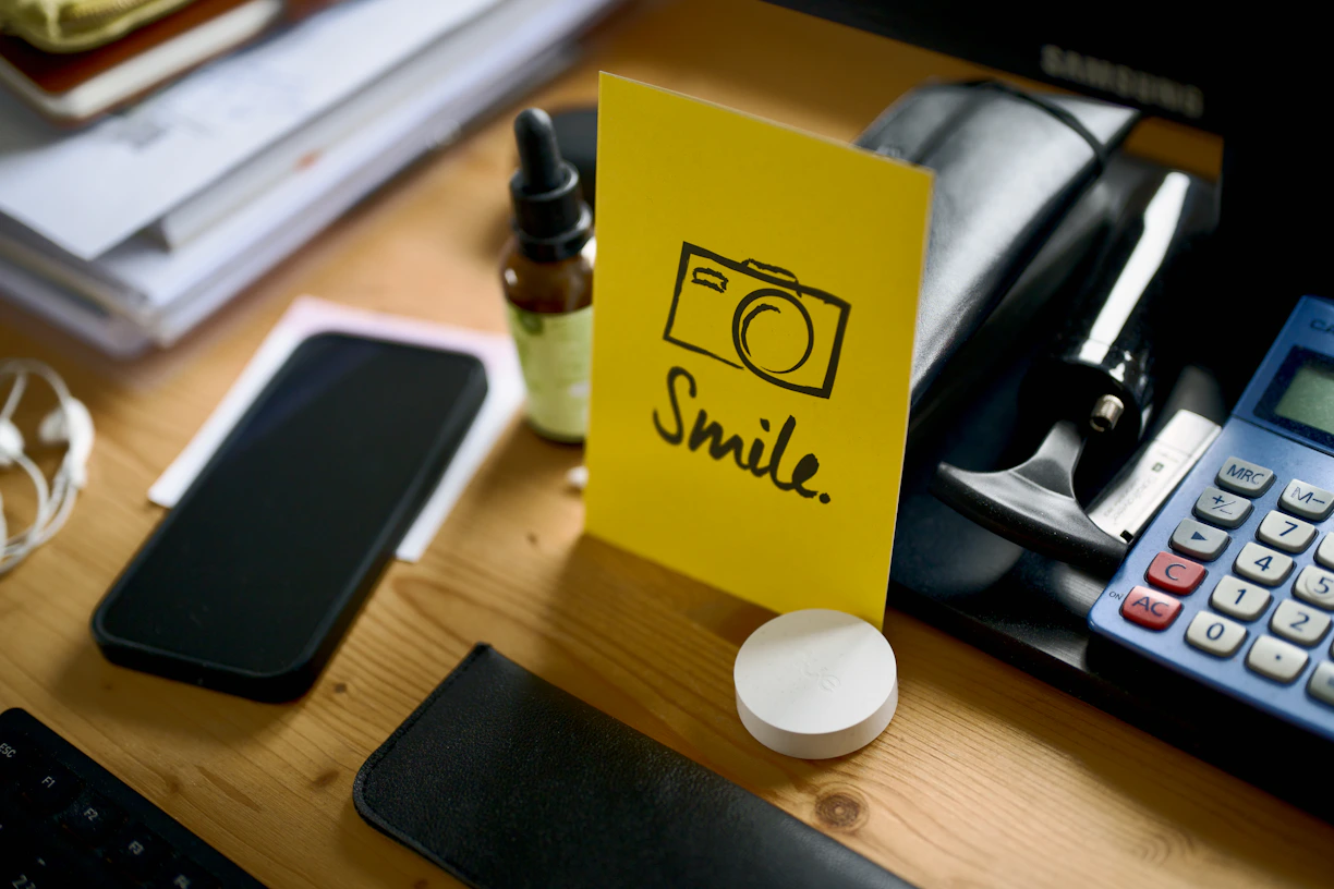 Yellow card with camera drawing and "smile."