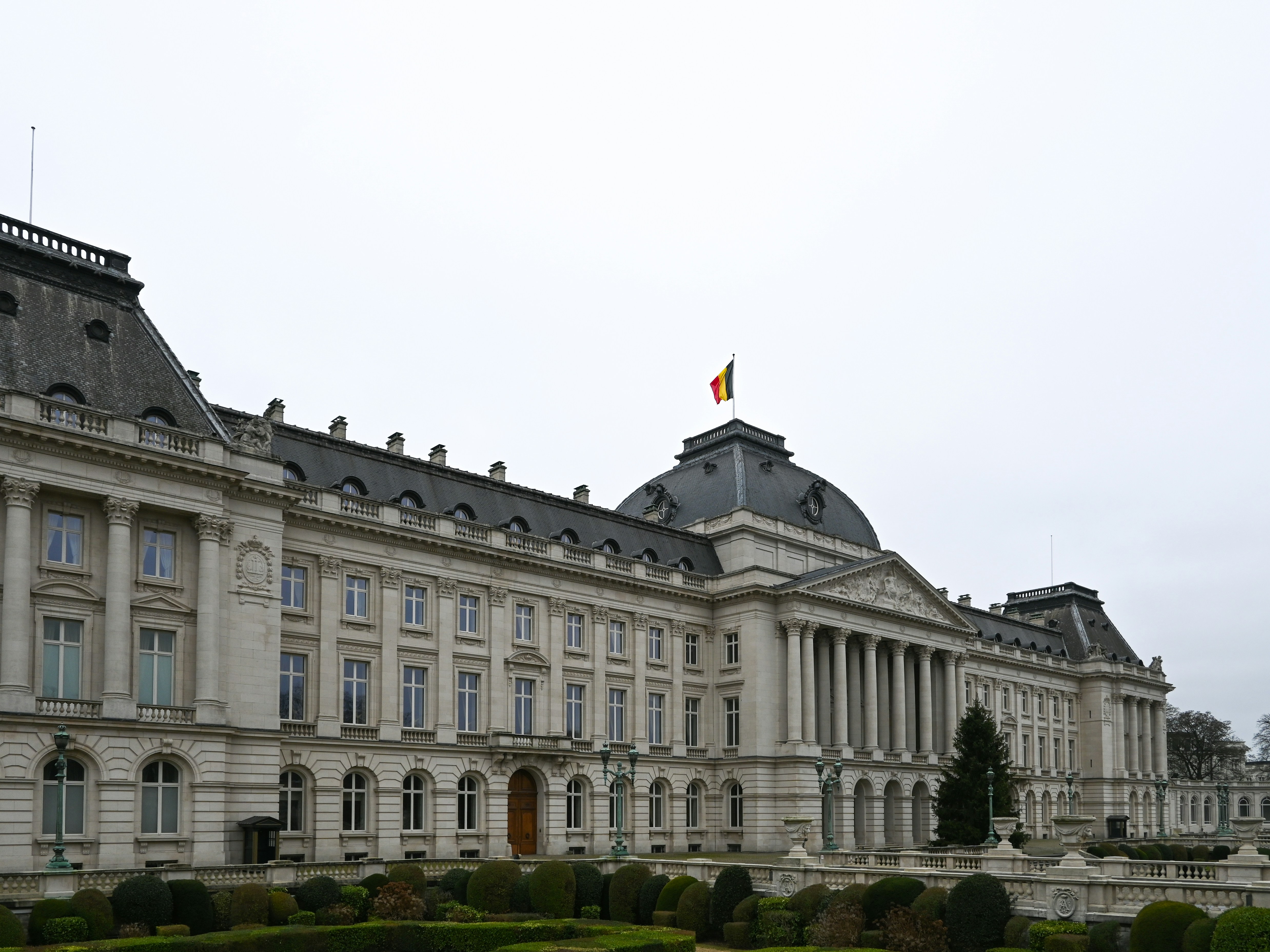 Grand neoclassical palace with a flag on top