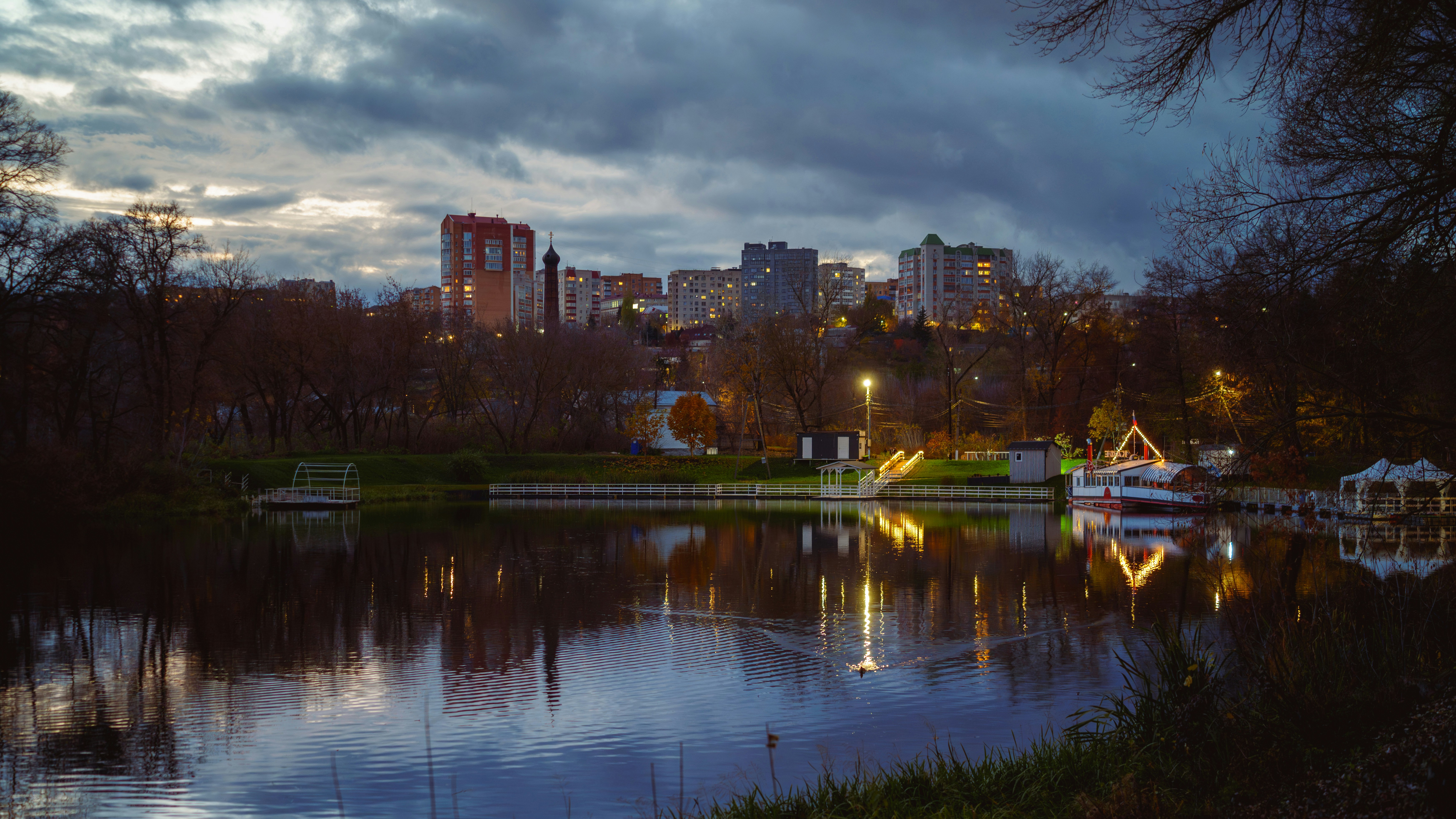 City skyline reflected in calm water at dusk