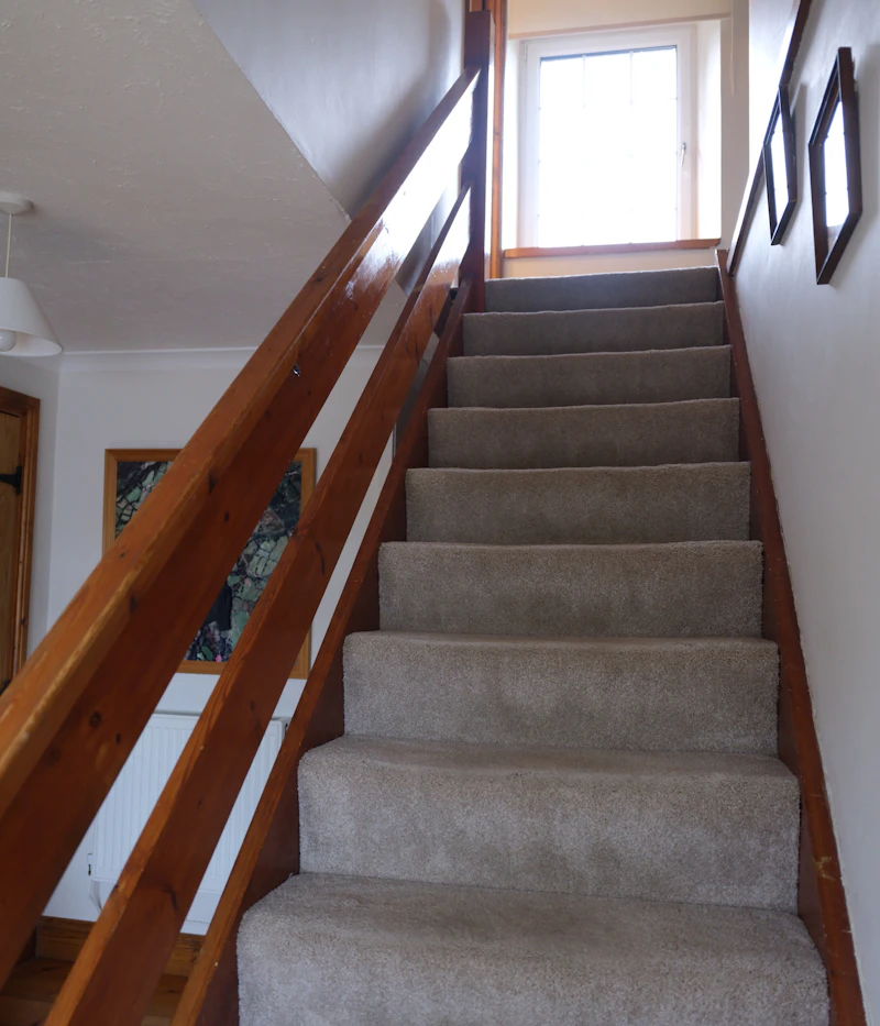 A neatly fitted carpeted staircase