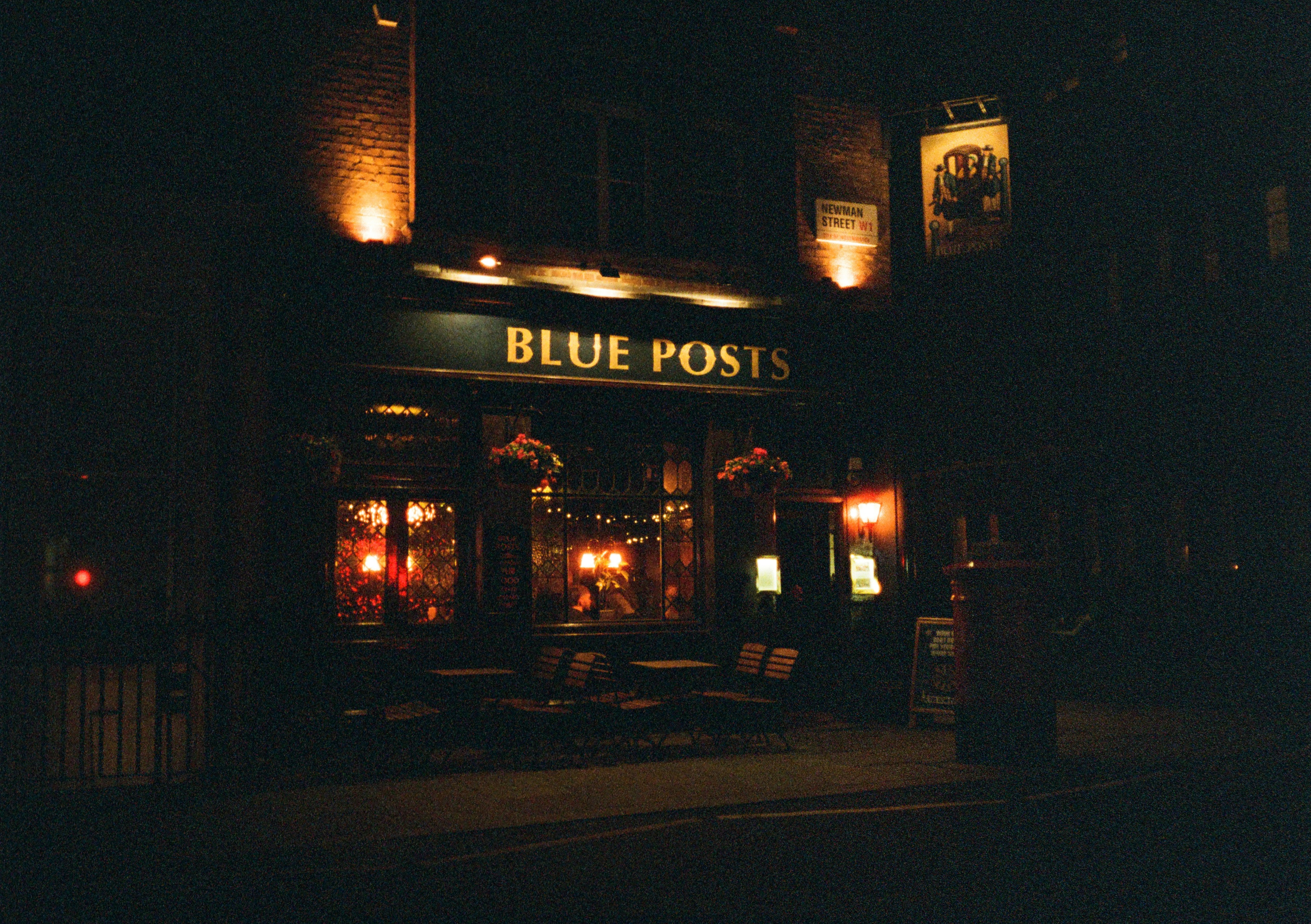 A dimly lit pub called blue posts at night